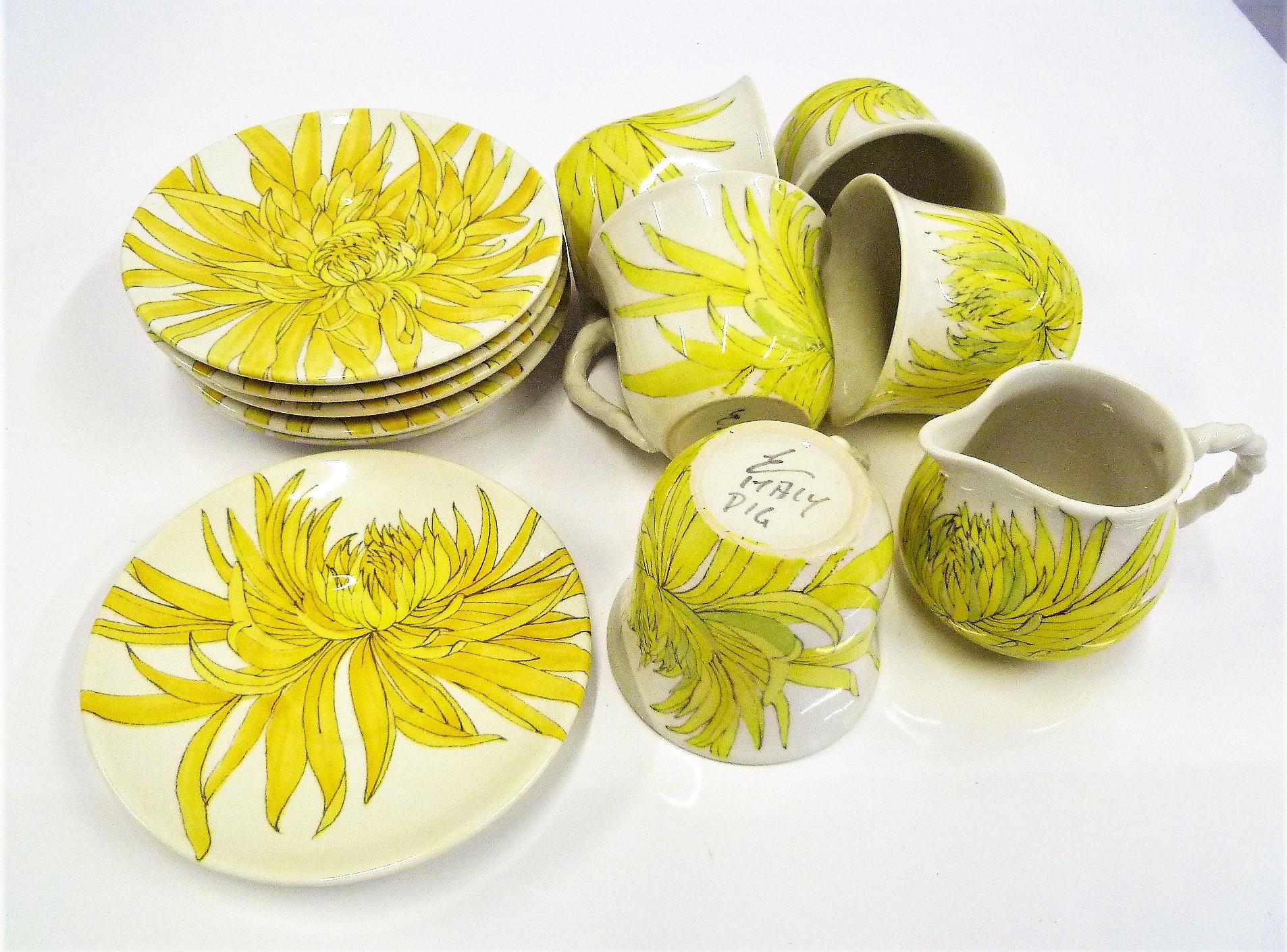 A set of 5 coffee cups and saucers plus a creamer with saucer in bright and cheerful Chrysanthemum pattern by Ceramiche Ernestine from Salerno in Northern Italy from the 1950s. Ernestine Cannon designed all patterns and shapes for her company. Her