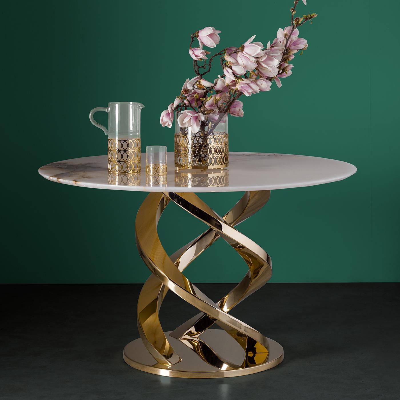 This magnificent dining table is part of the Home Couture collection, inspired by the glamour and bold character of Art Deco furniture. The 24-karat gold-plated stainless steel base rises up in three spiraling elements of great visual impact. The