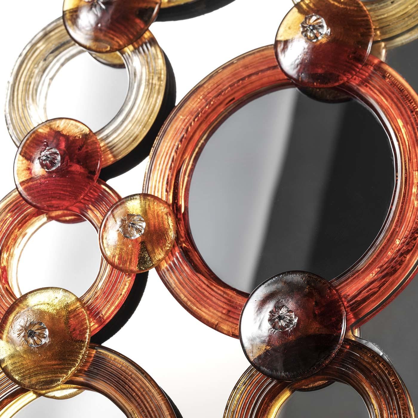 Part of the Cerchi collection (circles in English), this stunning mirror is a modern interpretation of traditional Venetian artifacts. The rectangular frame of this piece comprises a series of round elements of different sizes that are applied on