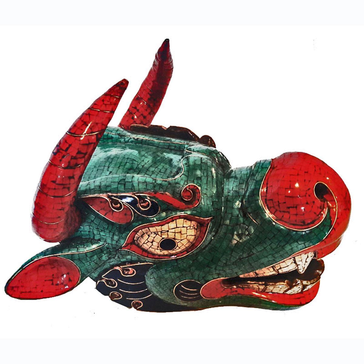 A superb ceremonial mask from Bhutan, used in ritual ceremonies. Made of polychromed wood, this ox mask is a colorful mosaic of red coral, bone, turquoise and lapis lazuli, with fine brass filigree to separate each material.