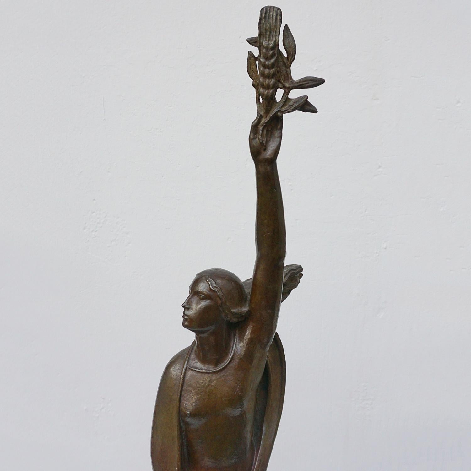 'Ceres' an Art Deco bronze sculpture by André Bizette-Lindet (1906-1988). Depicting Ceres, the Roman goddess of agriculture, fertility and motherly relationships, holding aloft a strand of Wheat, bear breasted with a shawl around her and her hair