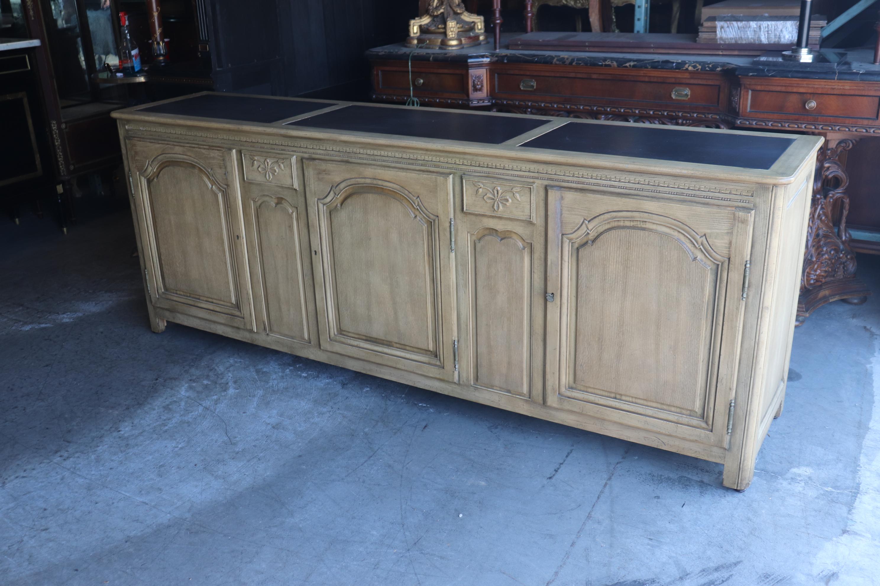 This is a gorgeous French country sideboard by Baker furniture company that is meant to conjure the feelings of being in the southern part of the French countryside where furniture like this was in every home. This grand sideboard has slate inserts