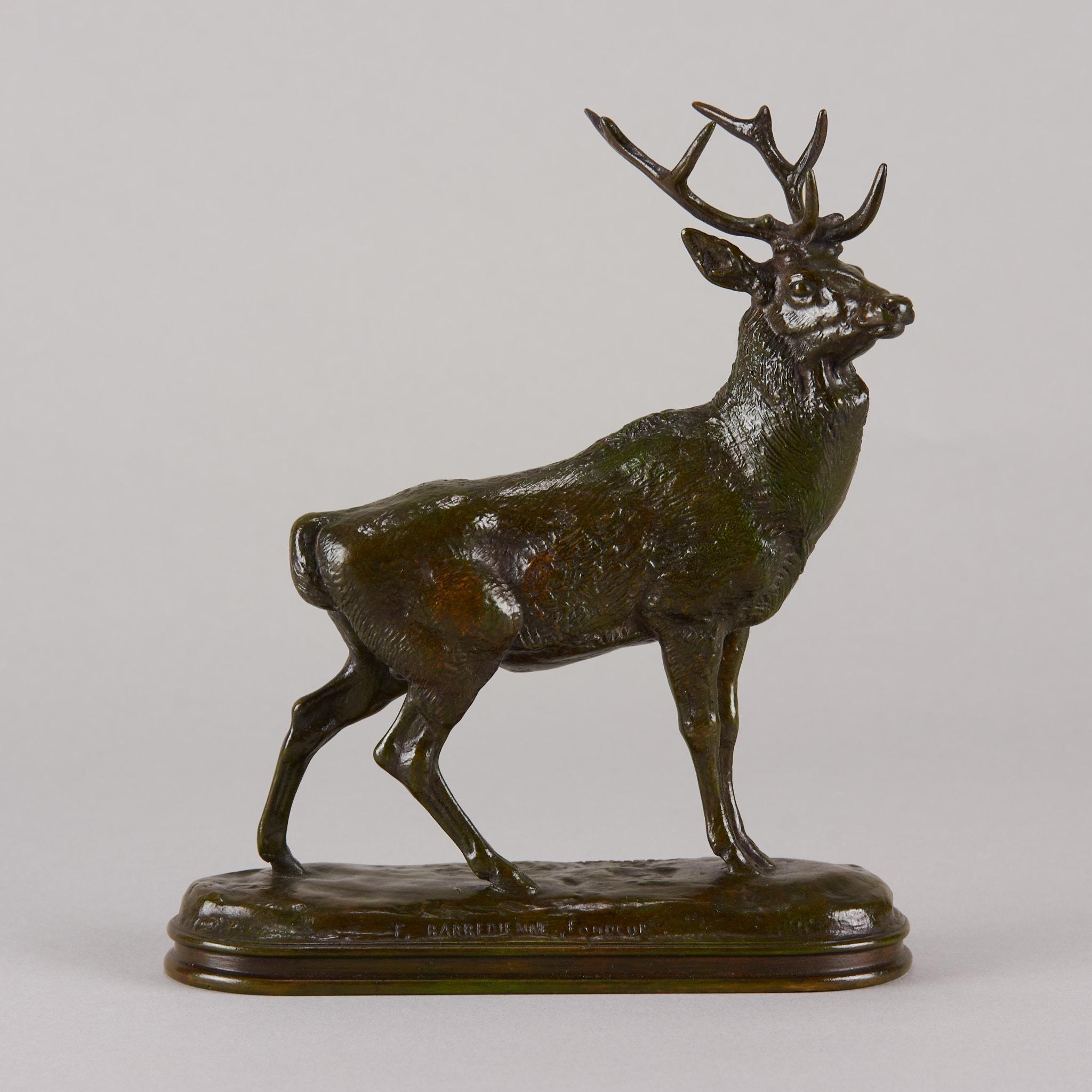 Magnificent late 19th century French bronze figure of an impressive alert stag with beautiful autumnal, green. black. brown and orange patination and excellent hand finished surface detail; raised on an oval naturalistic base with integral stepped