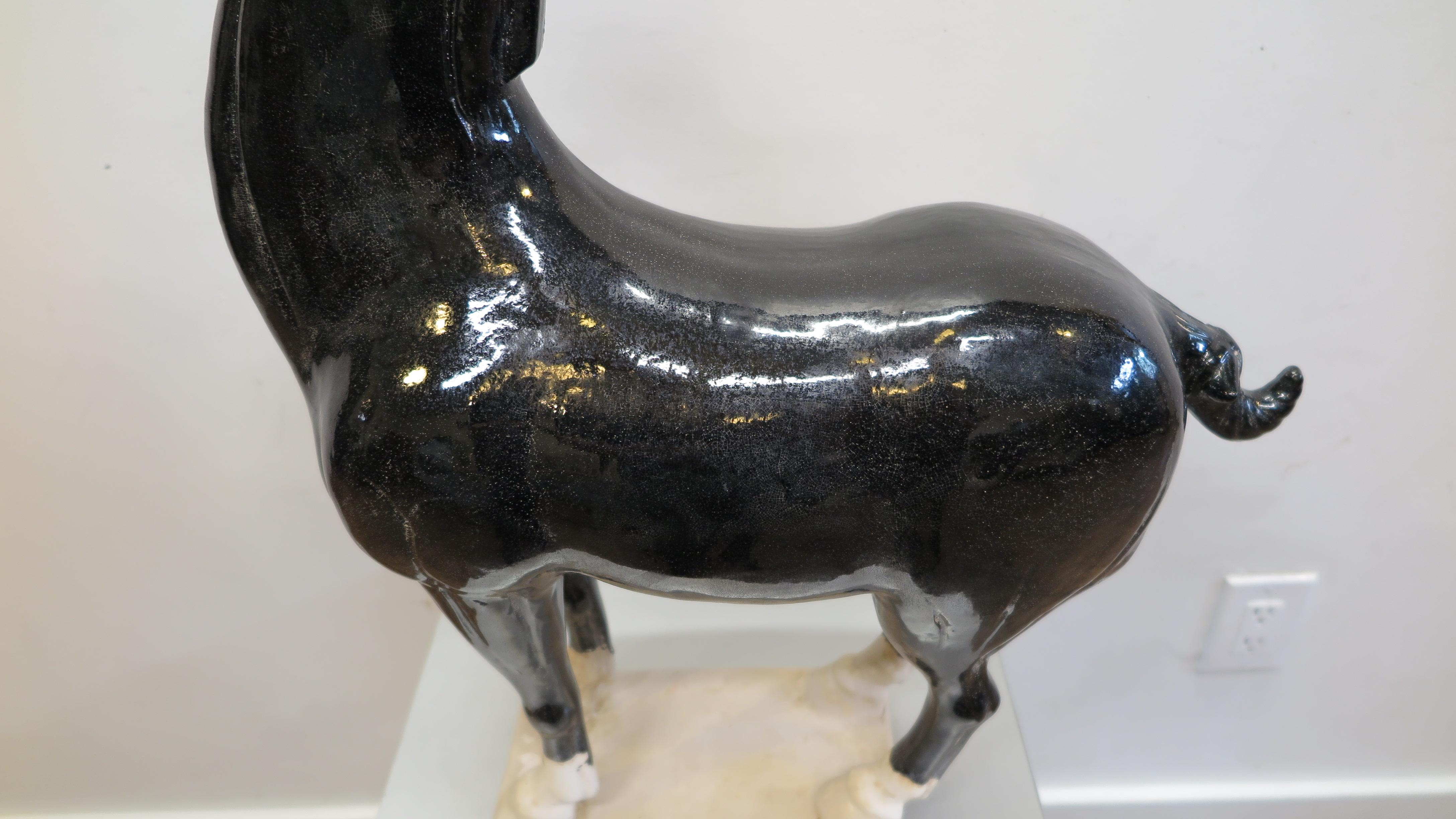 Ceramic horse sculpture in the style of Tang Dynasty Pottery. Late 20th century Chinese ceramic horse sculpture. Black crackle glaze over pottery. Very nice large scale piece. We have a similar White Horse that complements this black horse. See