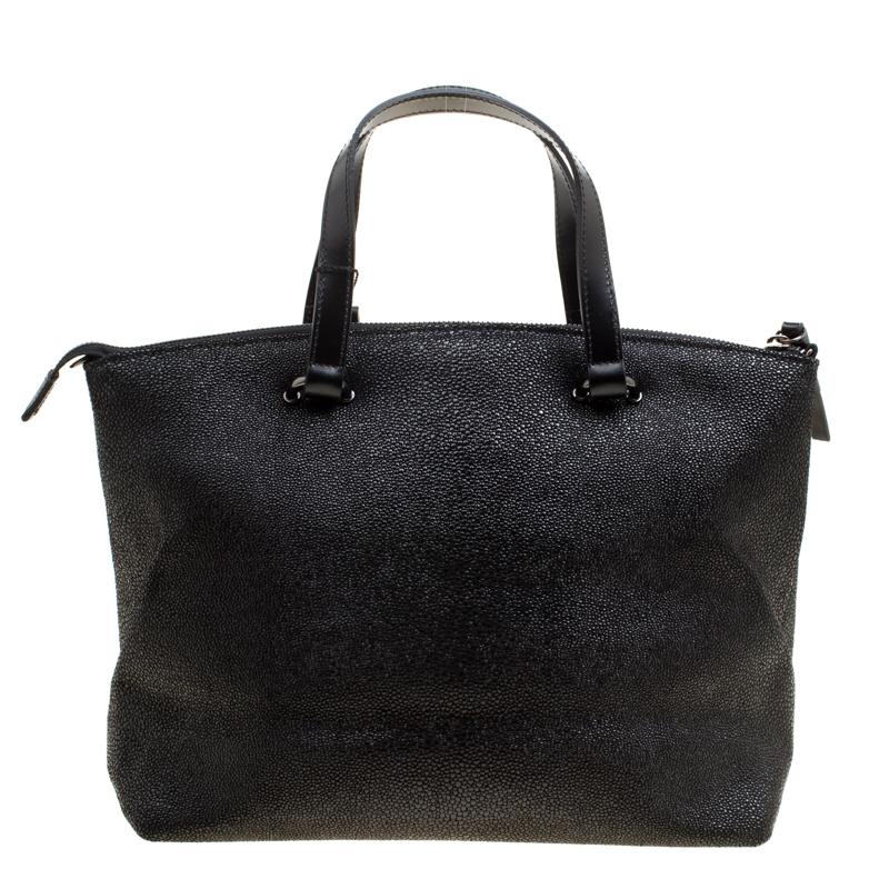 Cerruti has exclusively crafted this fancy handbag. Crafted with luxurious leather into a structured shape, this bag is everything you need to be the next big trendsetter. Lined with fabric on the insides, this tote is fitted with a zip pocket and