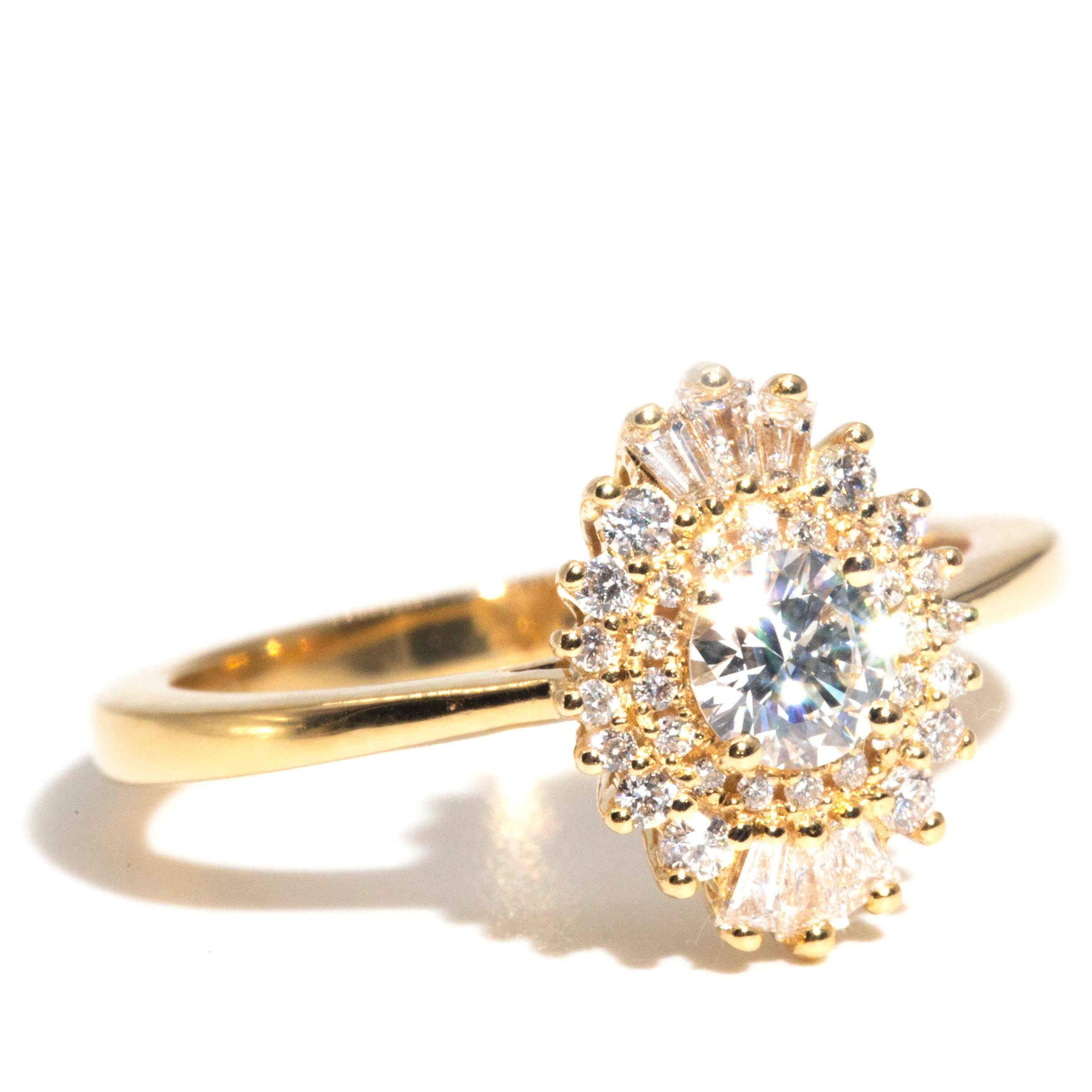 Thoughtfully crafted in 18 carat yellow gold, this breathtaking ring features an enchanting certified 0.30 carat round brilliant diamond shimmering inside a ballerina border of 0.35 carats of gorgeous round brilliant and tapered baguette cut