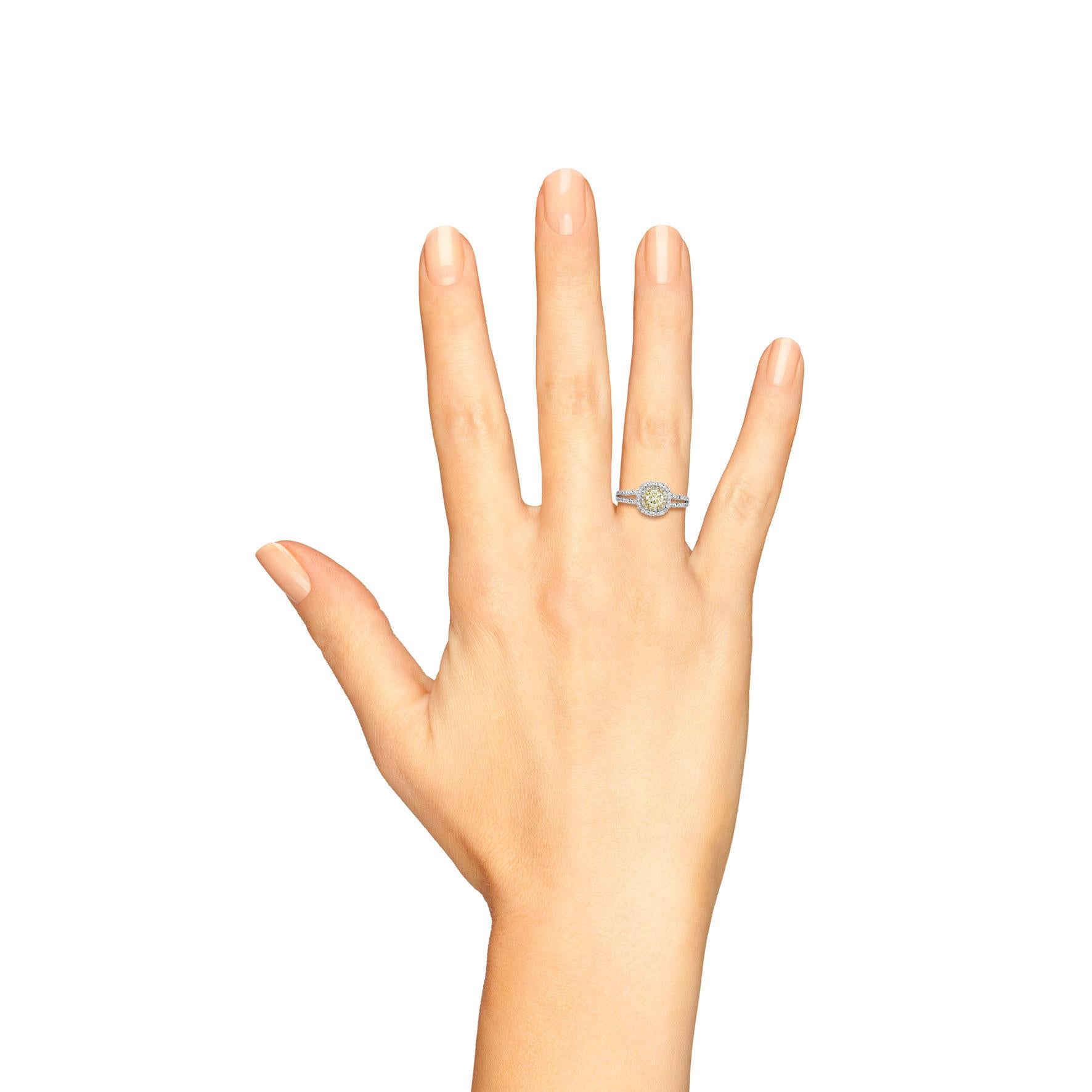 This breathtaking piece features a stunning 0.5 Ct. fancy light yellow diamond at its center, radiating warmth and beauty. The split shank design not only enhances the elegance of the ring but also provides a modern twist to traditional engagement