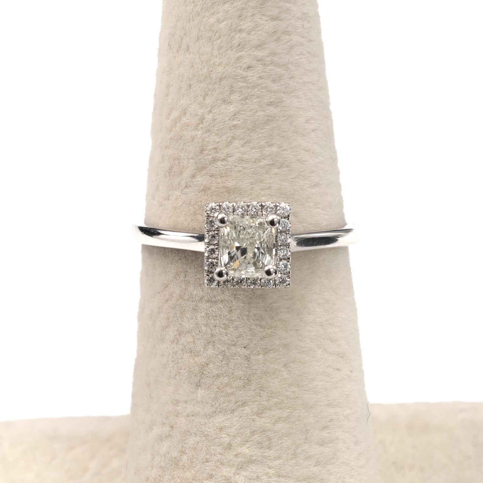 A contemporary square halo diamond engagement ring, featuring a 0.65 Carat radiant cut certified diamond.

Crafted in 18 karat white gold by our expert artisans partners in the UK, the contemporary ring is fully hallmarked and comes with a full