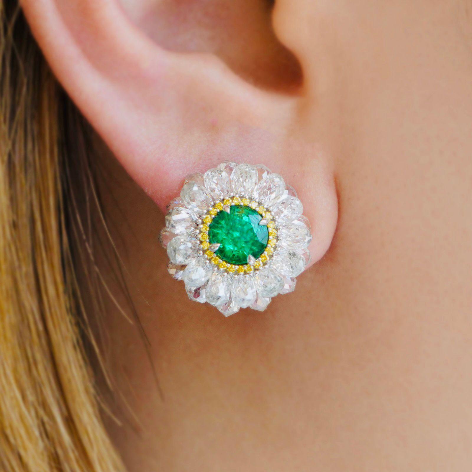 With such an unusual and striking combination of stones and colors, the composition of these Contemporary Zambian Emerald Diamond Halo Button Earrings, made in the 21st century, immediately draws us in. The earrings are crafted in 18K white gold and