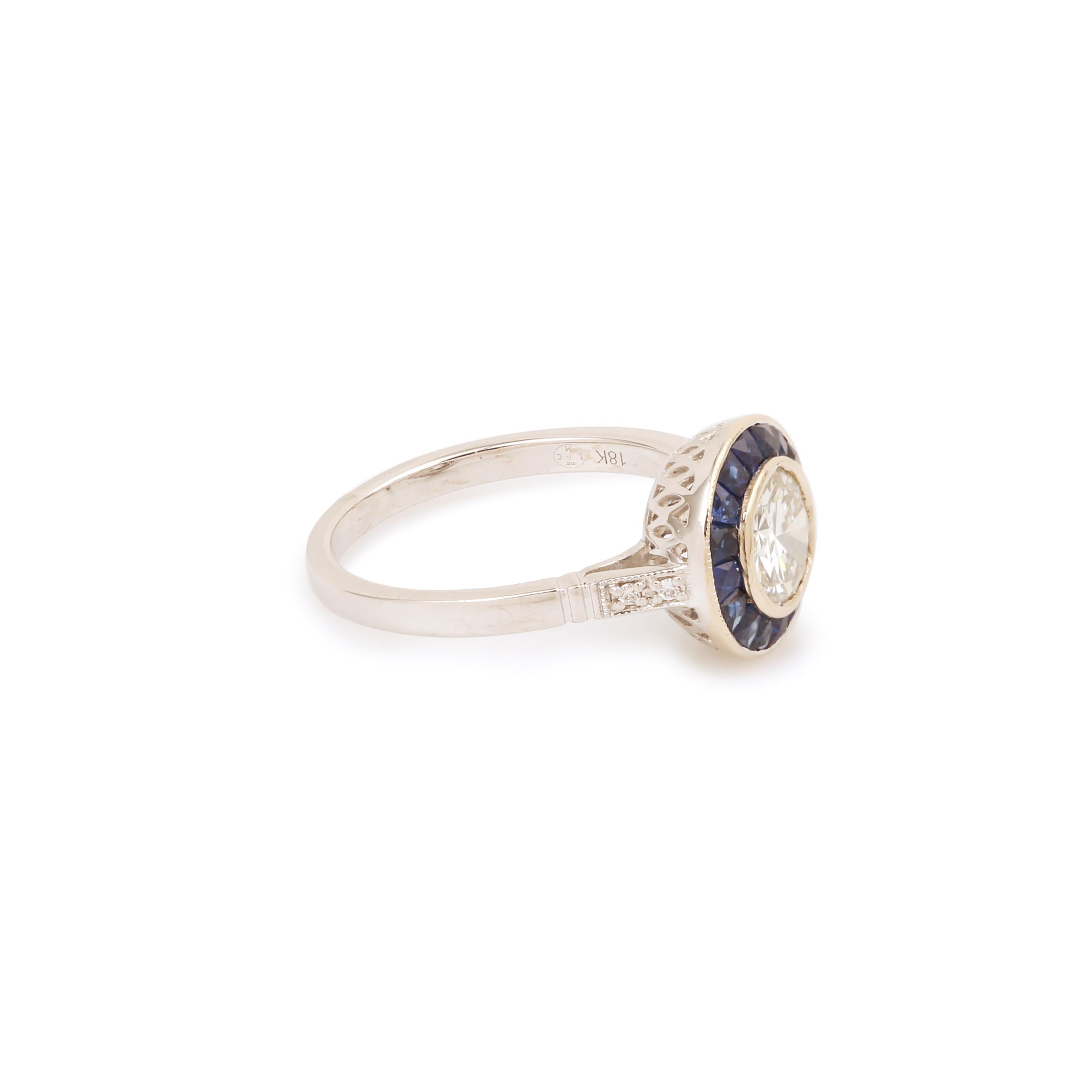 Art Deco style ring in white gold set with a diamond in a sapphire surround, the shoulders paved with diamonds.

Central diamond weight: 0.94 carats

With a Carat Gem Lab certificate specifying color I, purity SI1, no fluorescence.

Total estimated