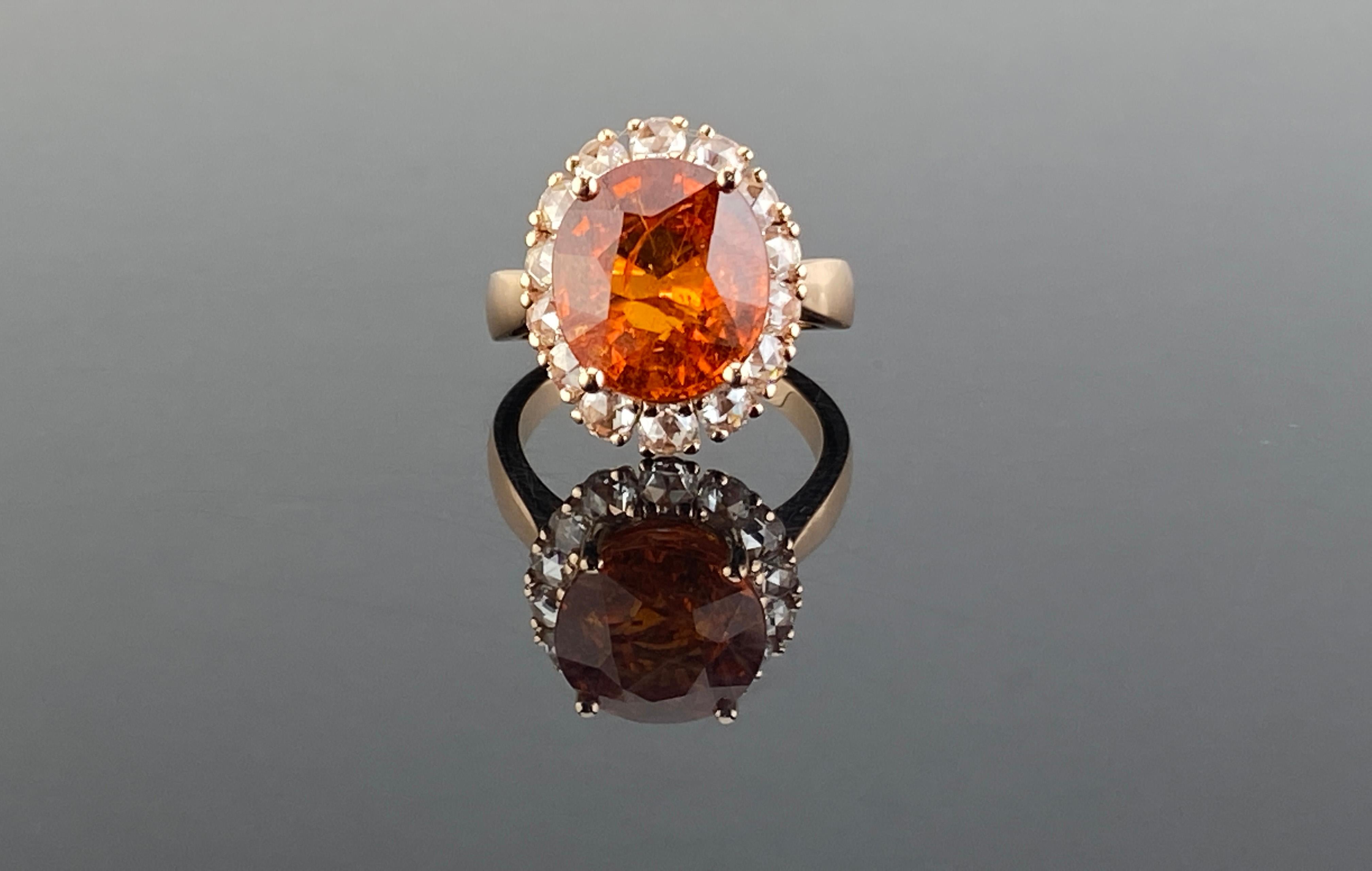 A lovely 18K pink gold ring featuring a fine spessartine garnet with a rich royal orange color giving it the trade name “mandarin.” It weighs 10.03 carats and has exceptional clarity for a mandarin garnet, which allows the stones natural bright