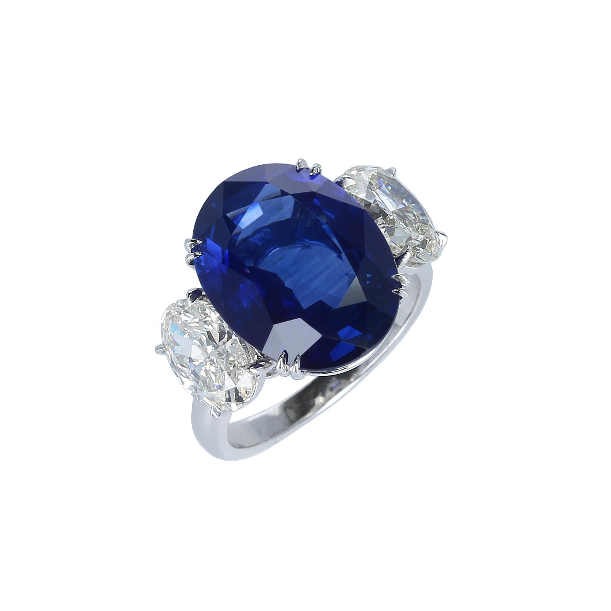 A classic and vibrant three-stone oval sapphire and diamond ring set with an impressive ten-carat plus oval shape mixed-cut sapphire from Ceylon (Sri Lanka), accented with two GIA certified oval brilliant-cut diamonds weighing a total of 2.59