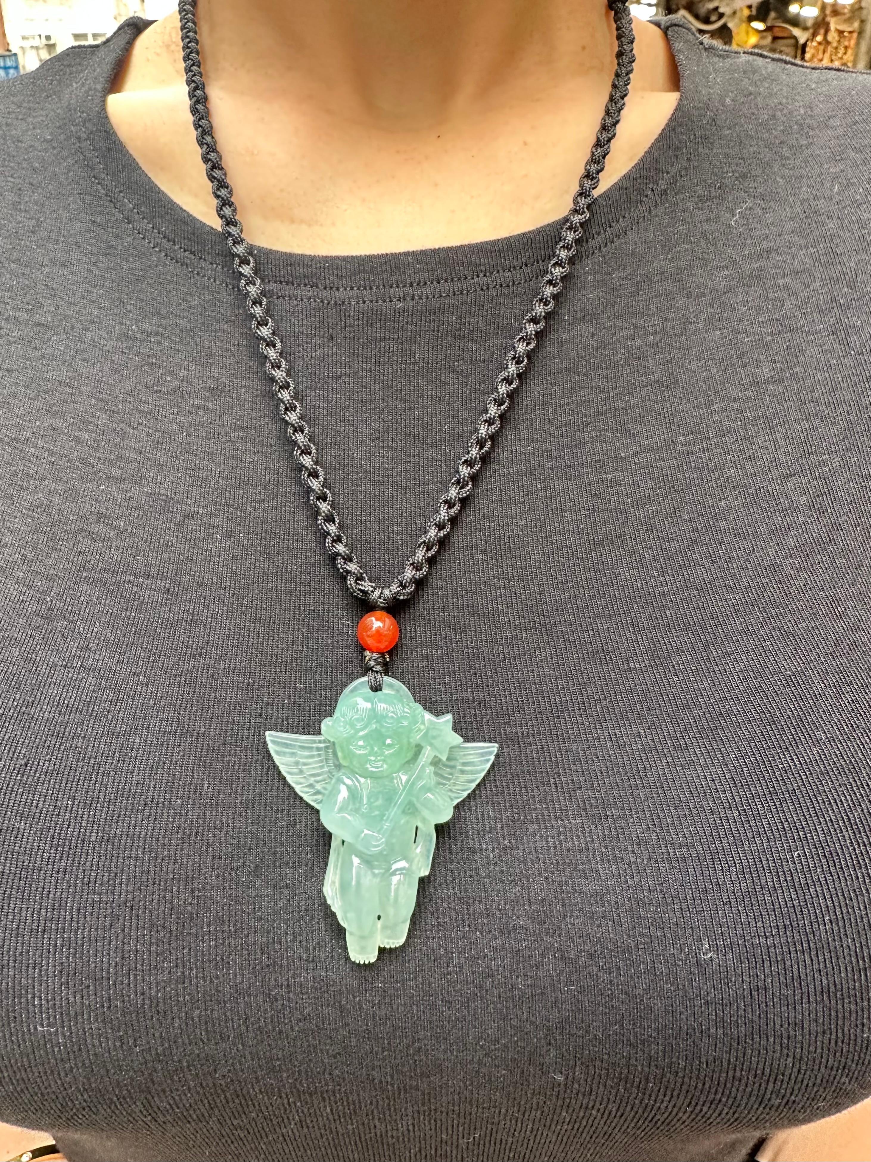 Please check out the HD video. This certified natural jadeite jade is over 100 carats, un-enhanced and untreated. The angel of protection jade pendant is exceptionally carved. The jade pendant is matched simply with a red agate bead. The light green
