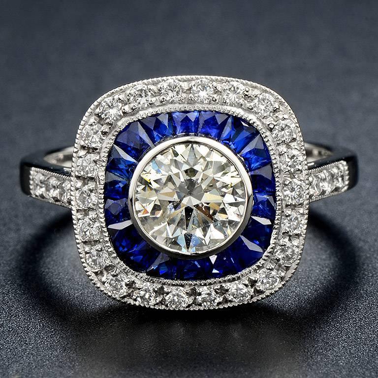 1.01 Carat Brilliant Cut Diamond H Color I1 Clarity (Certified by EGL) is set on gorgeous Art Deco Ring with French-cut Blue Sapphire 18 pieces 1.60 Carat and 28 pieces 0.42 Carat of side Diamond. 
This Ring was made in Platinum 950. Size US#7.

*