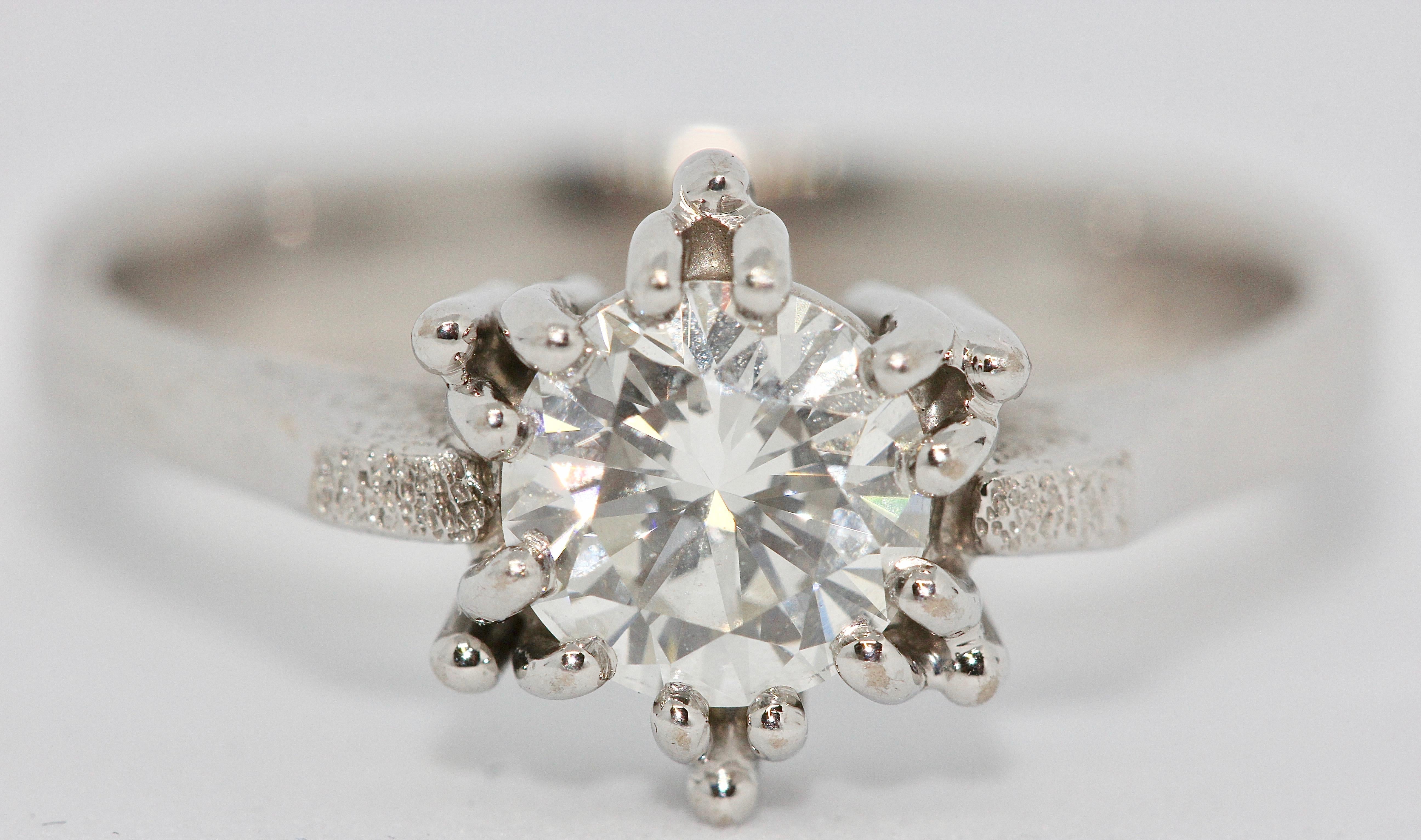 An almost perfect Diamond Solitaire, 18 Karat white Gold Ring.

1.01 Carat 
Flawless
Top Wesselton 
Cut: Very Good