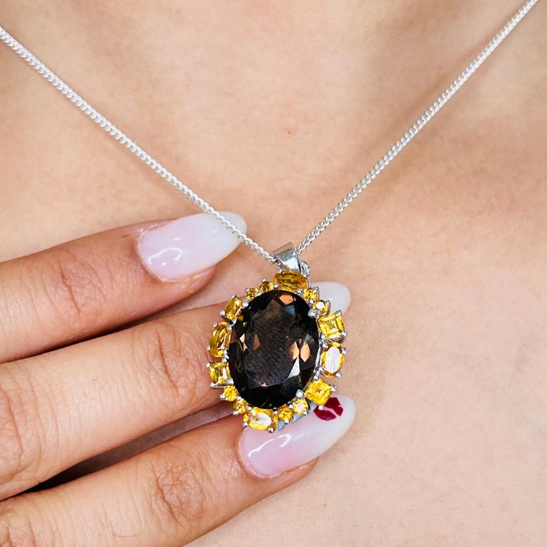 Certified 10.5 Carat Natural Smoky and Citrine Pendant in sterling silver studded with mixed cut smoky topaz, citrine. This stunning piece of jewelry instantly elevates a casual look or dressy outfit. 
Smoky Topaz, Citrine Gemstone enhances the