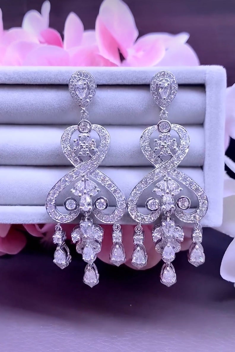 These remarkable earrings are a true masterpiece of design, combining various shapes and sizes of stones , and intricate designs so elegantly . Adorn yourself with exceptional craftsmanship and breathtaking design that will leave everyone