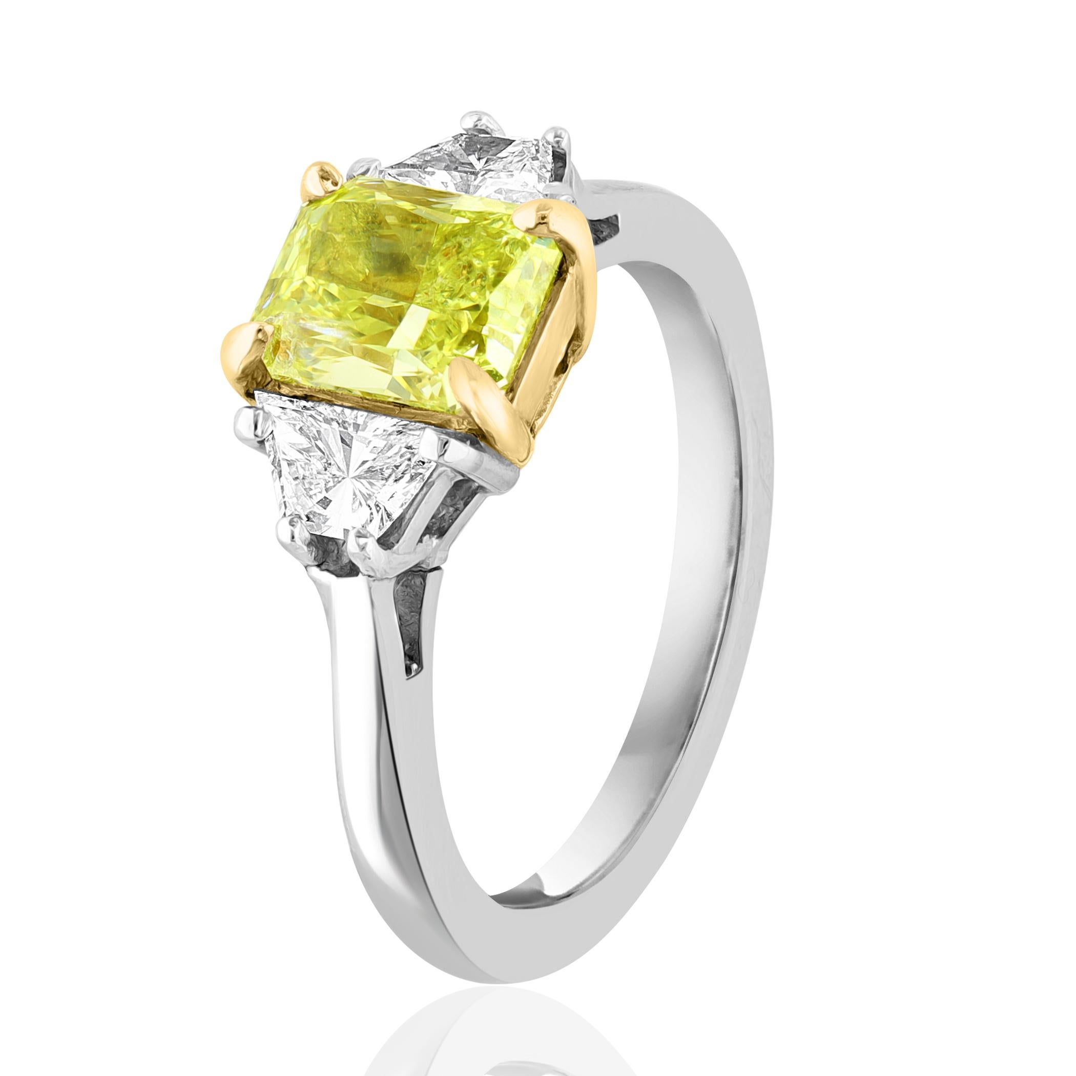 Showcasing Certified Emerald cut, Fancy Intense color Yellow Diamond weighing 1.06 carat, flanked by two brilliant cut trapezoids diamonds weighing 0.49 carats total. Elegantly set in a polished platinum composition.