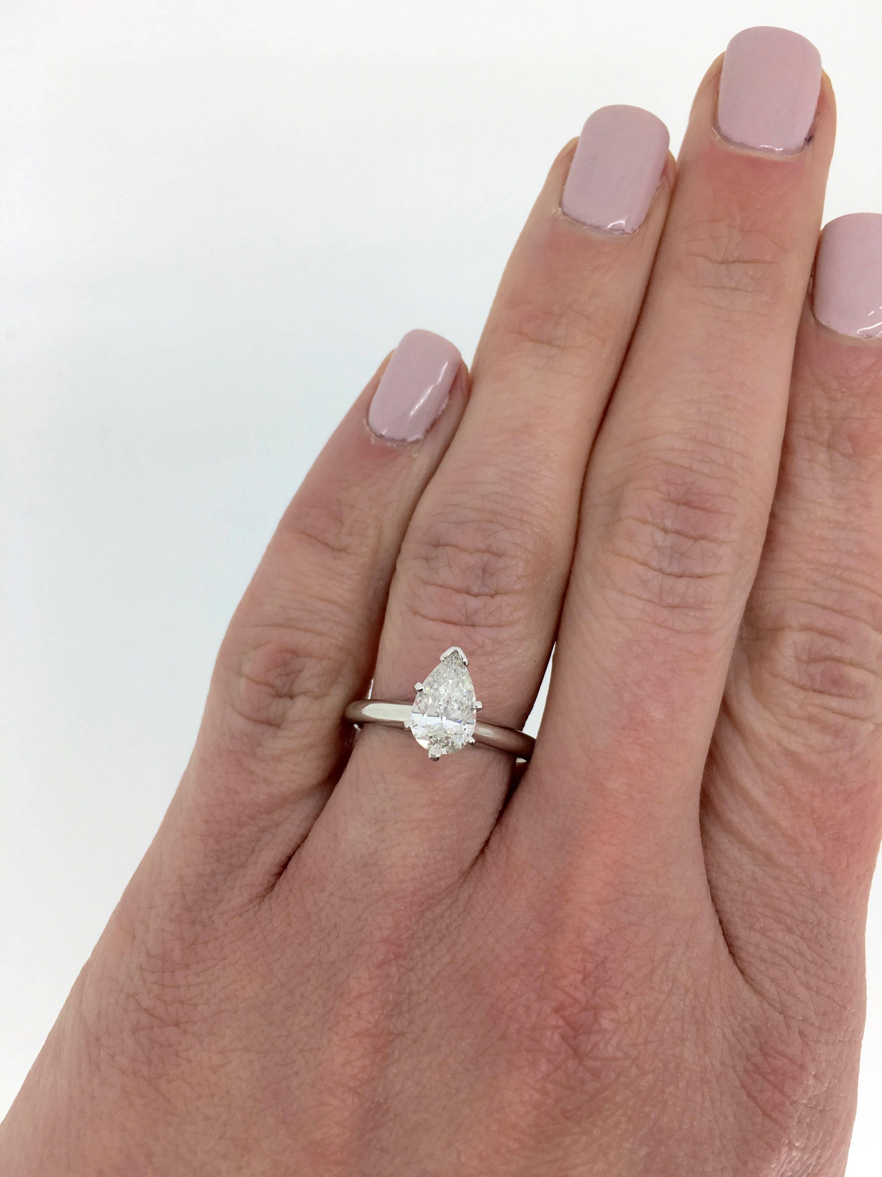 This engagement ring features a GSI Certified 1.06CT Pear Cut Diamond with I color and I1 clarity. The diamond is set in a classic Platinum 6 prong setting. The ring is a size 6 and weighs 4.1 grams.