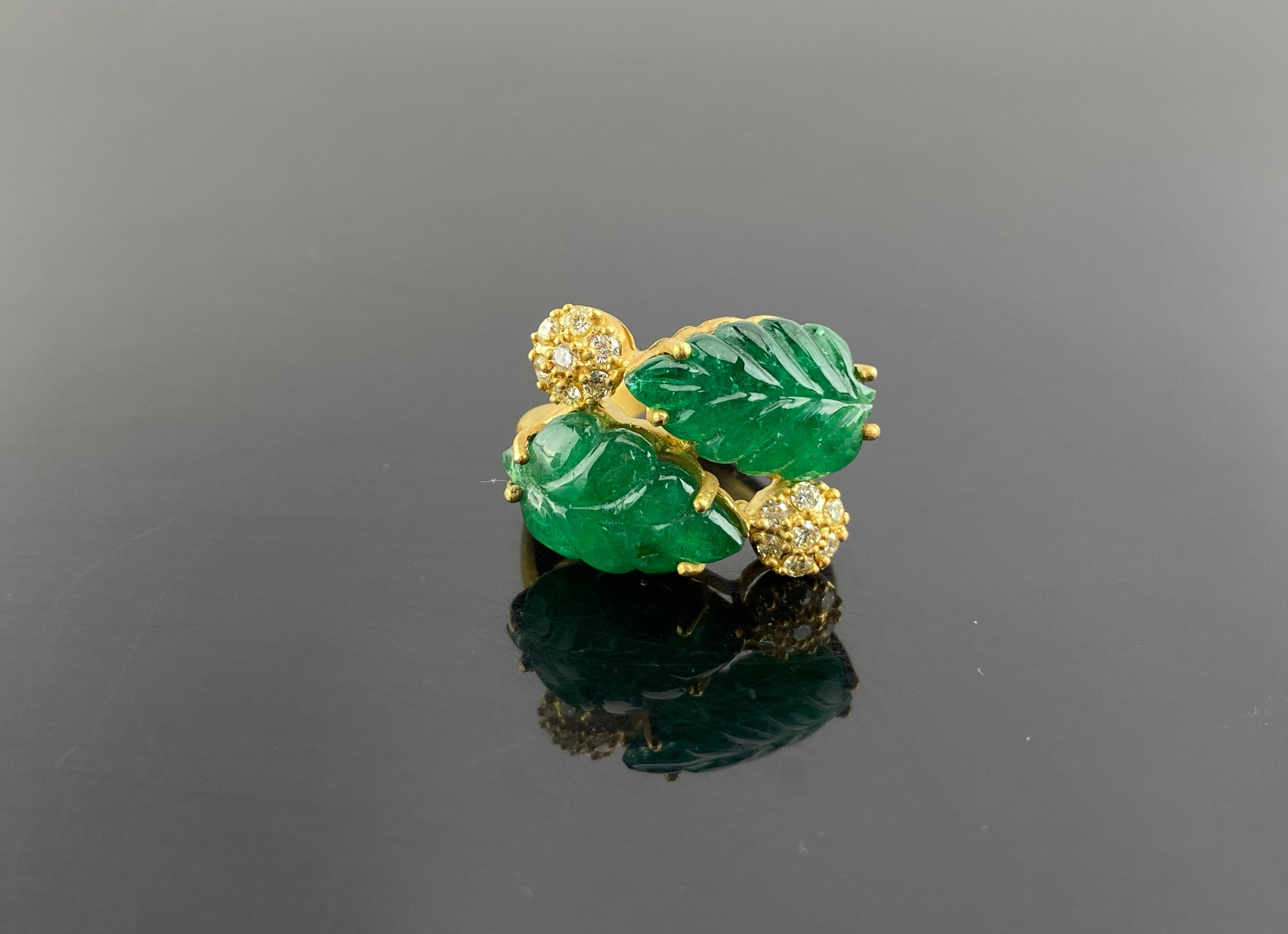  An Emerald Cocktail Ring set in 18K Gold & Diamonds. The weight of the Emerald Carvings carving is 11 carats. The Emerald is completely natural, without any treatment and is of Zambian origin. The Emeralds are hand-carved into leaves in our very