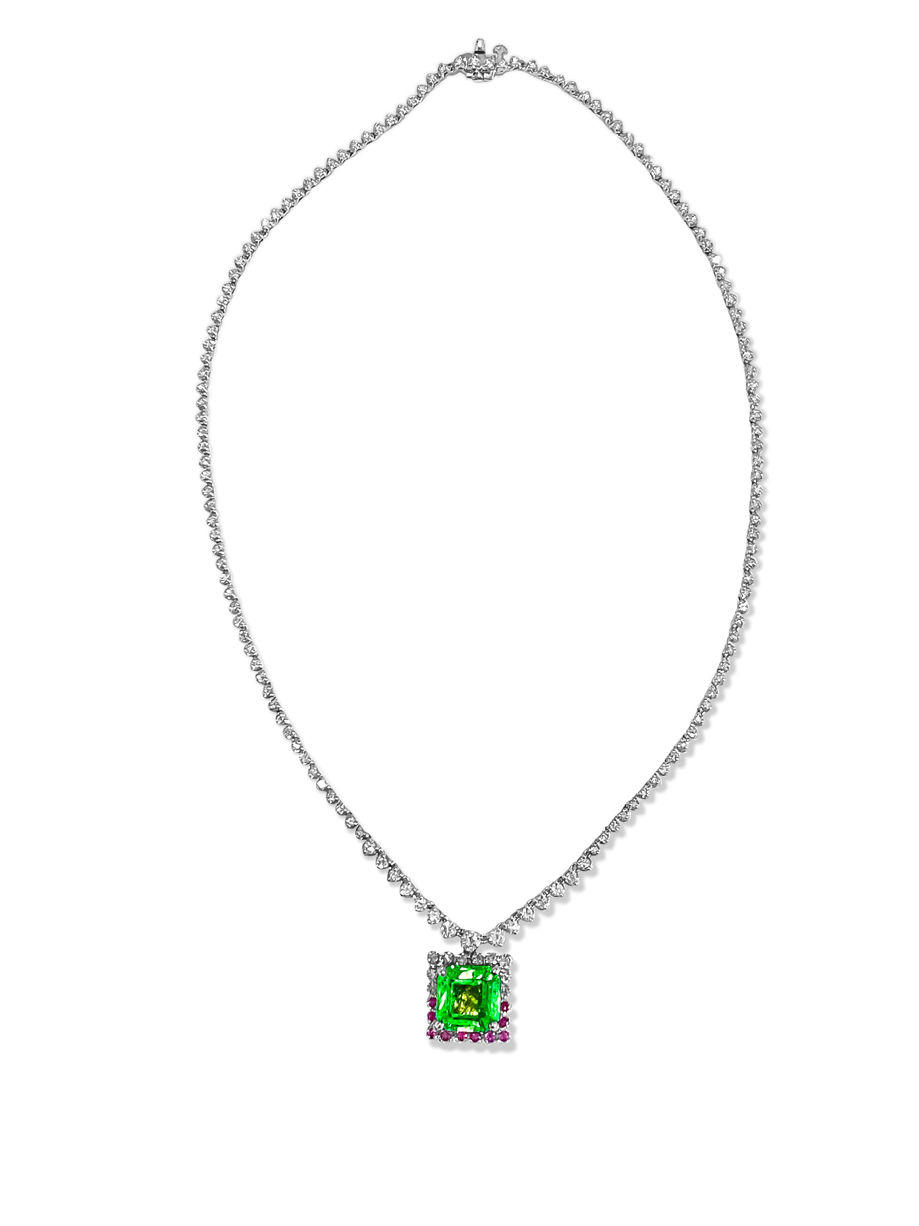 Metal: 14K White Gold. 
5.50 Carat, 100% natural earth mined Colombian Emerald. Emerald cut emerald.

5.00 carat diamonds total. SI Clarity and G color diamonds. Round brilliant cut. 100% natural earth mined.

0.50 Carat natural Burma ruby. 100%