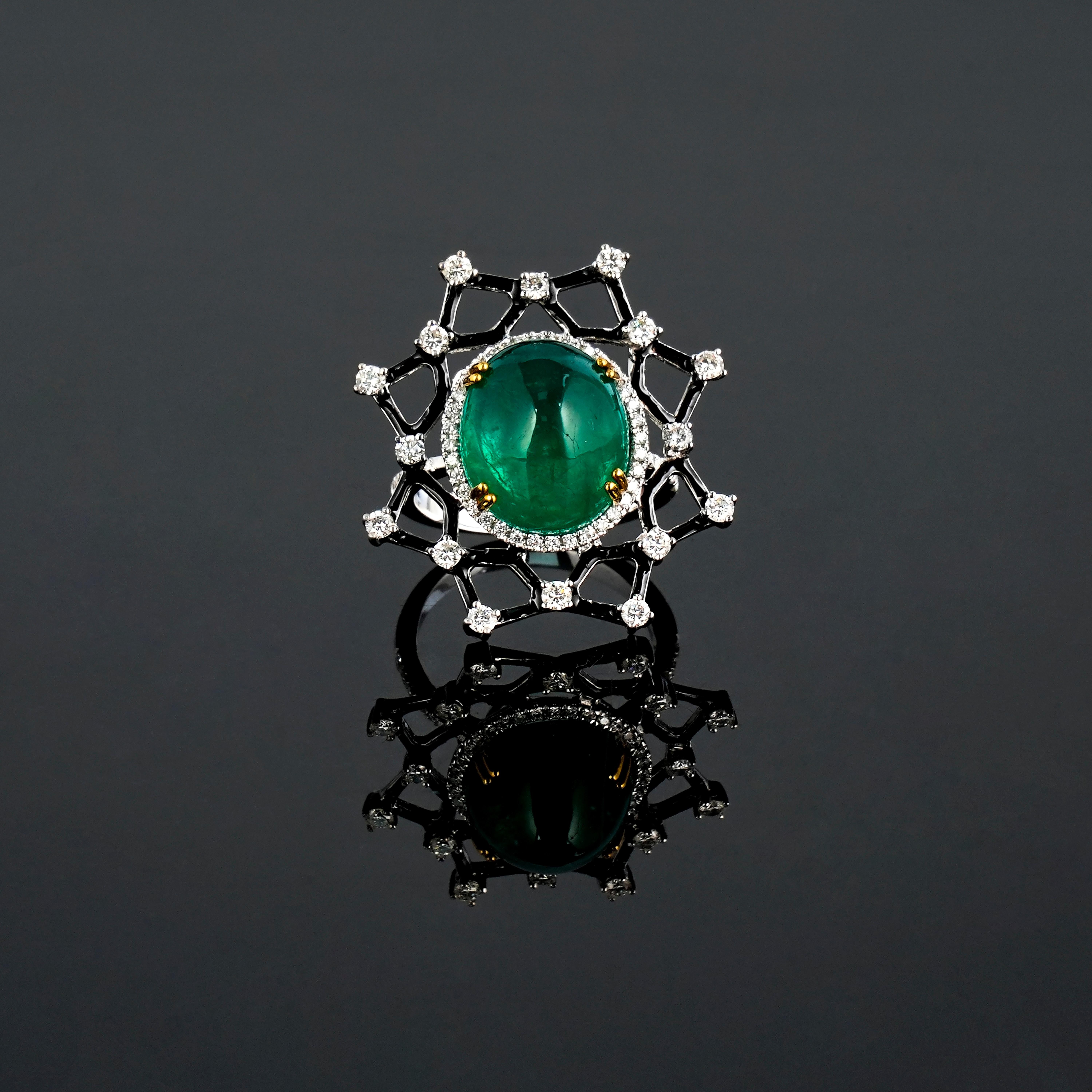A one of a kind 11.07 carat Emerald cabochon and 0.88 carat White Diamond cocktail ring, with black enamel. The design of the ring is very unique, and the center stone Emerald has an ideal vivid green color, and great luster, making it a very high
