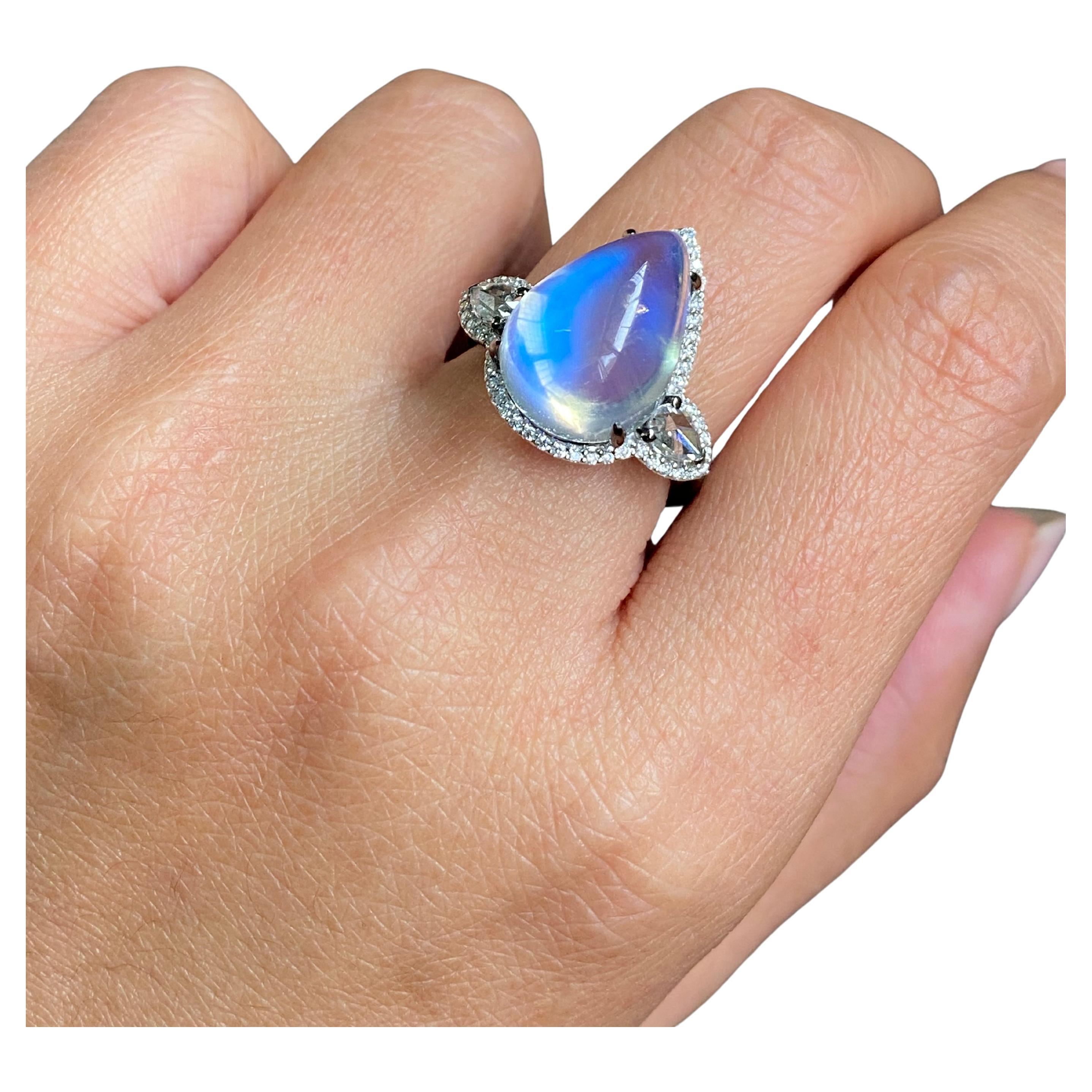 A statement 11.67 carat pear shape cabochon Moonstone (16.6mm x 11.9mm) and 0.68 carat Diamond three stone engagement cocktail ring, set in solid 18K White Gold, with black rhodium polish. The rose cut side stones are 0.34 carat total. The rose cut