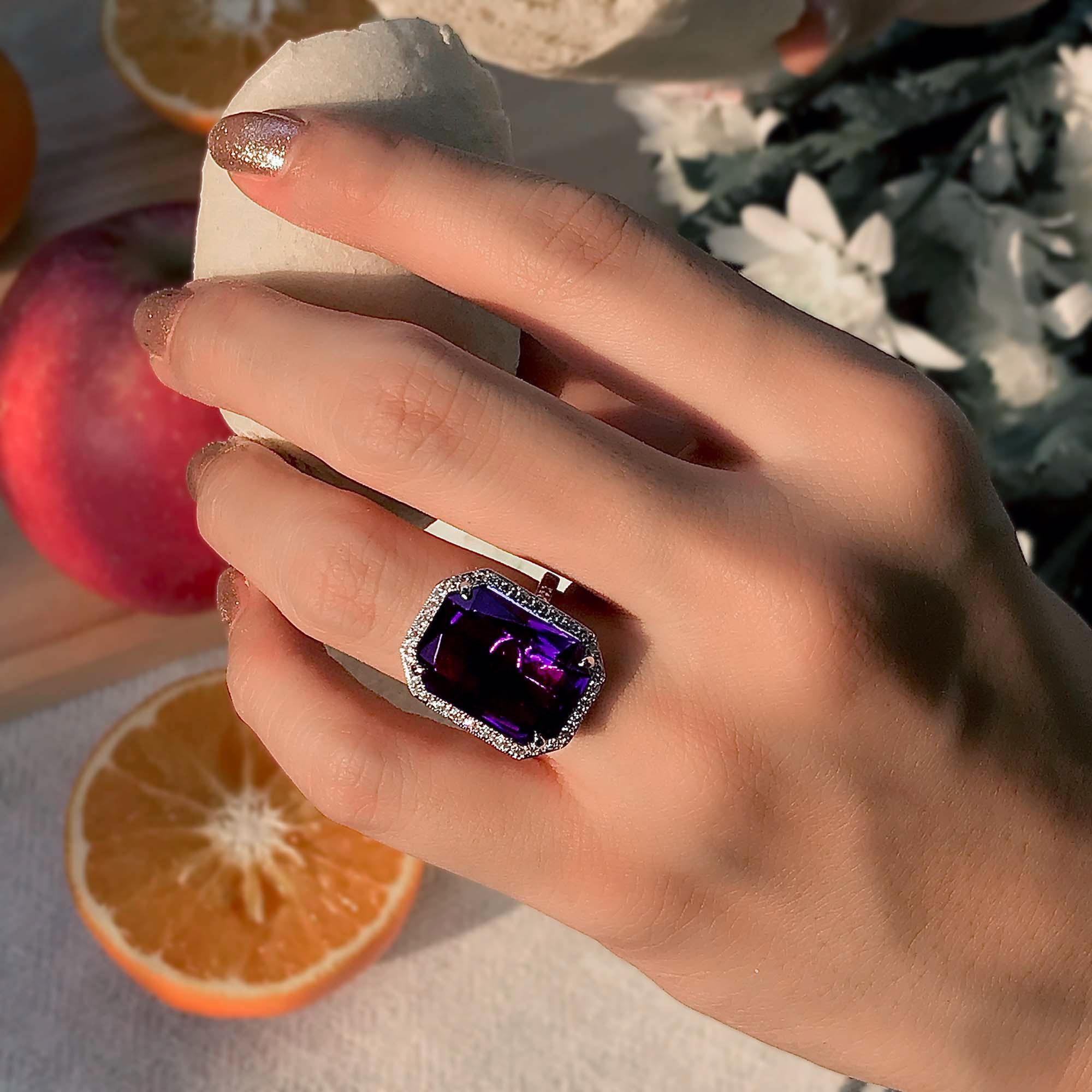 This beautiful Art Deco style amethyst ring is centered with an emerald cut amethyst and accented with sparkling diamond halo. The ring is craft of 18k white gold. Adorn yourself with this February birthstone jewelry.

Ring Information
Style: Art