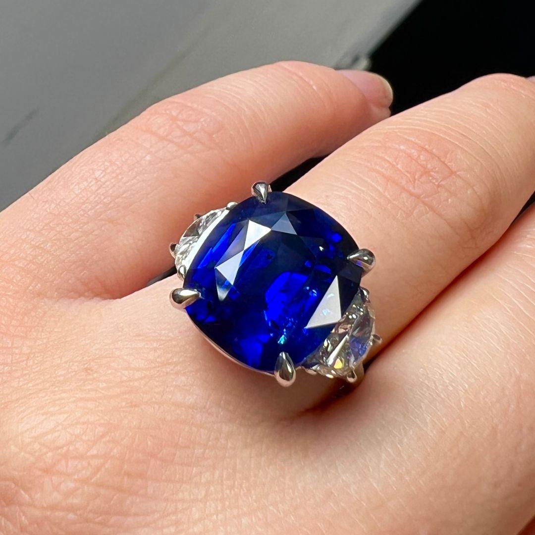 Sapphire Weight: 11.79 Carats
Diamond Weight: 1.00 Carat ( H color, VS clarity)
Metal: Platinum
Ring Size: 7
Shape: Cushion
Color: Blue
Hardness: 9
Birthstone: September
CD Certified