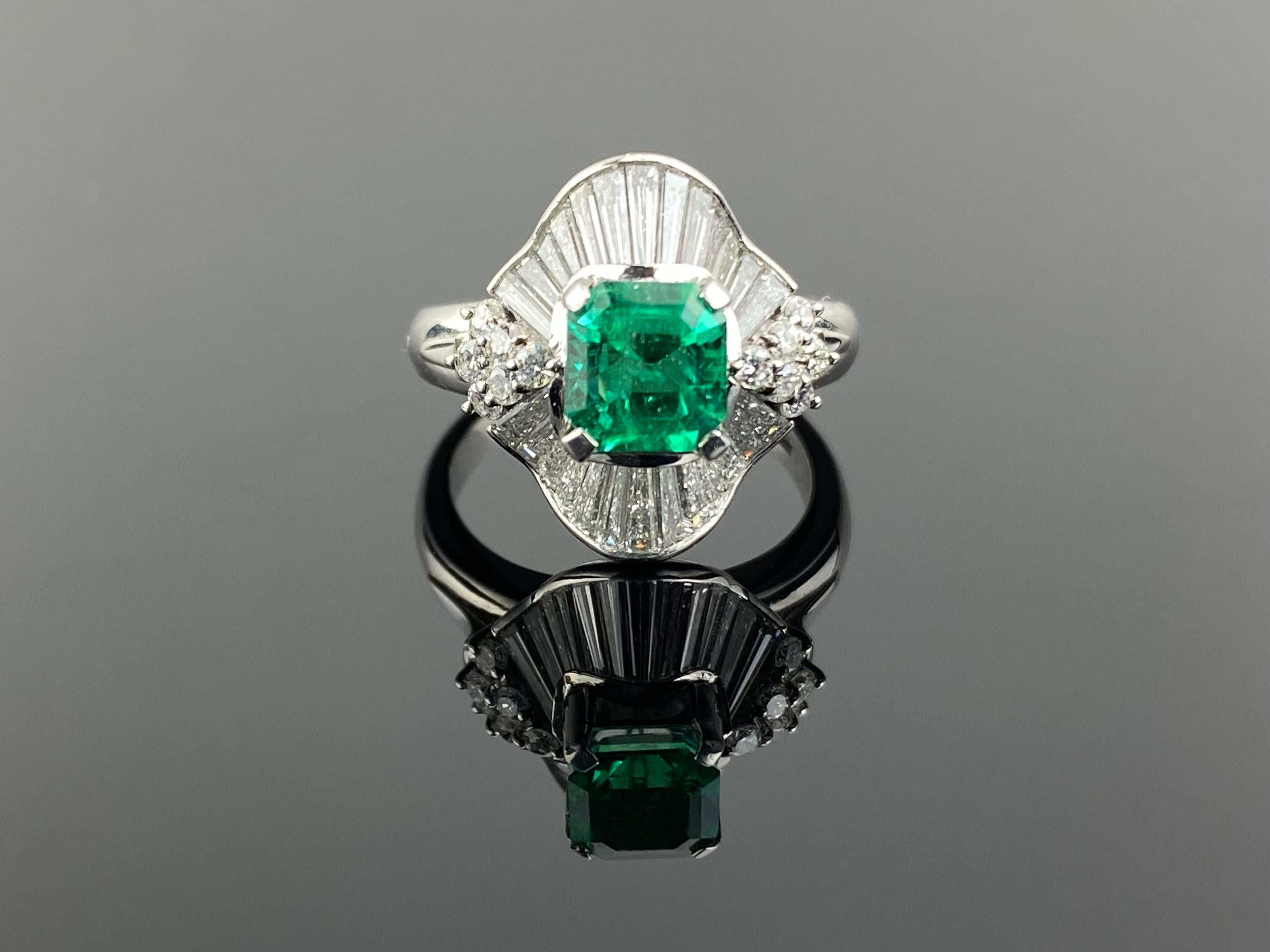 A classic, art-deco 1.18 carat Colombian Emerald and 1.34 carat Diamond baguette ring, set in platinum. The center stone has an ideal vivid green color, and a great shine/luster to it. The Emerald is transparent, and is of a very high quality. The