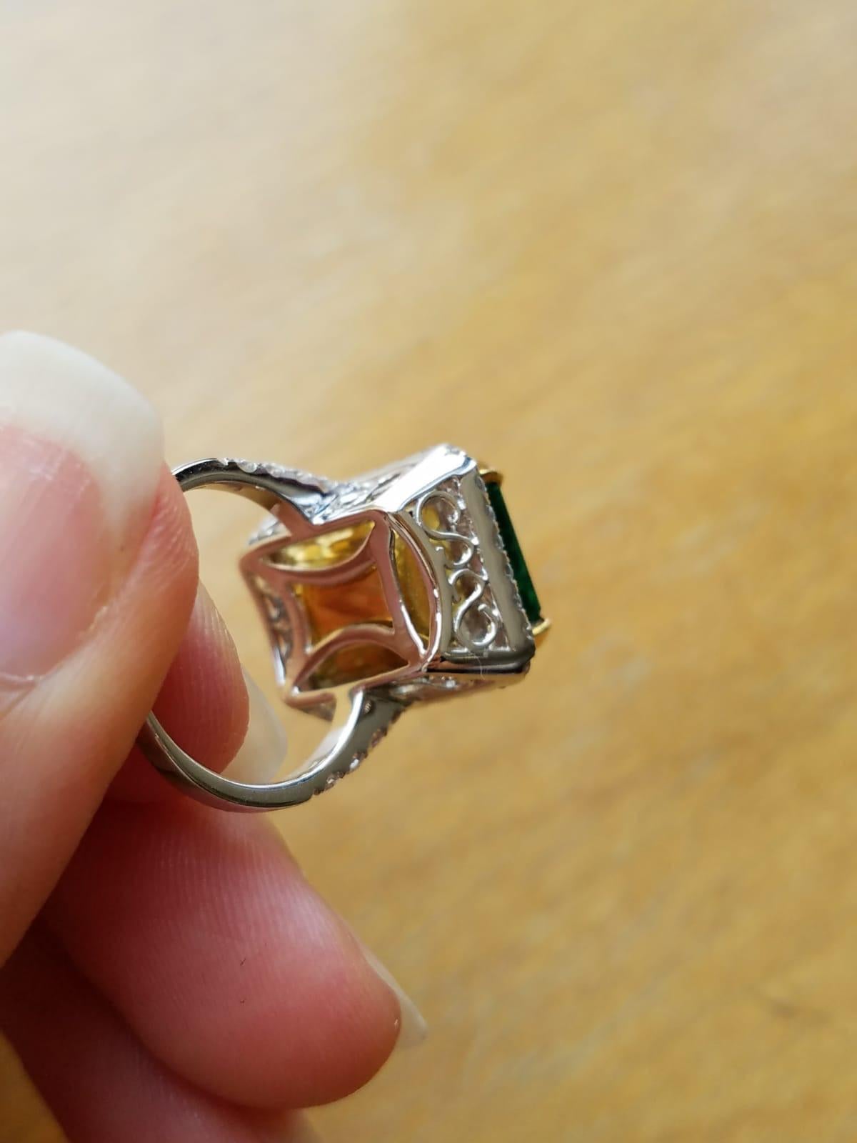 Beautiful and Lustrous, High Quality Zambian Emerald Cocktail Ring outlined with Diamond, all set in 18K White Gold and Yellow Gold prongs. 

Stone Details:  
Stone: Zambian Emerald
Cut: Emerald Cut
Carat Weight: 11.95 carat

Diamond Details:
Cut: