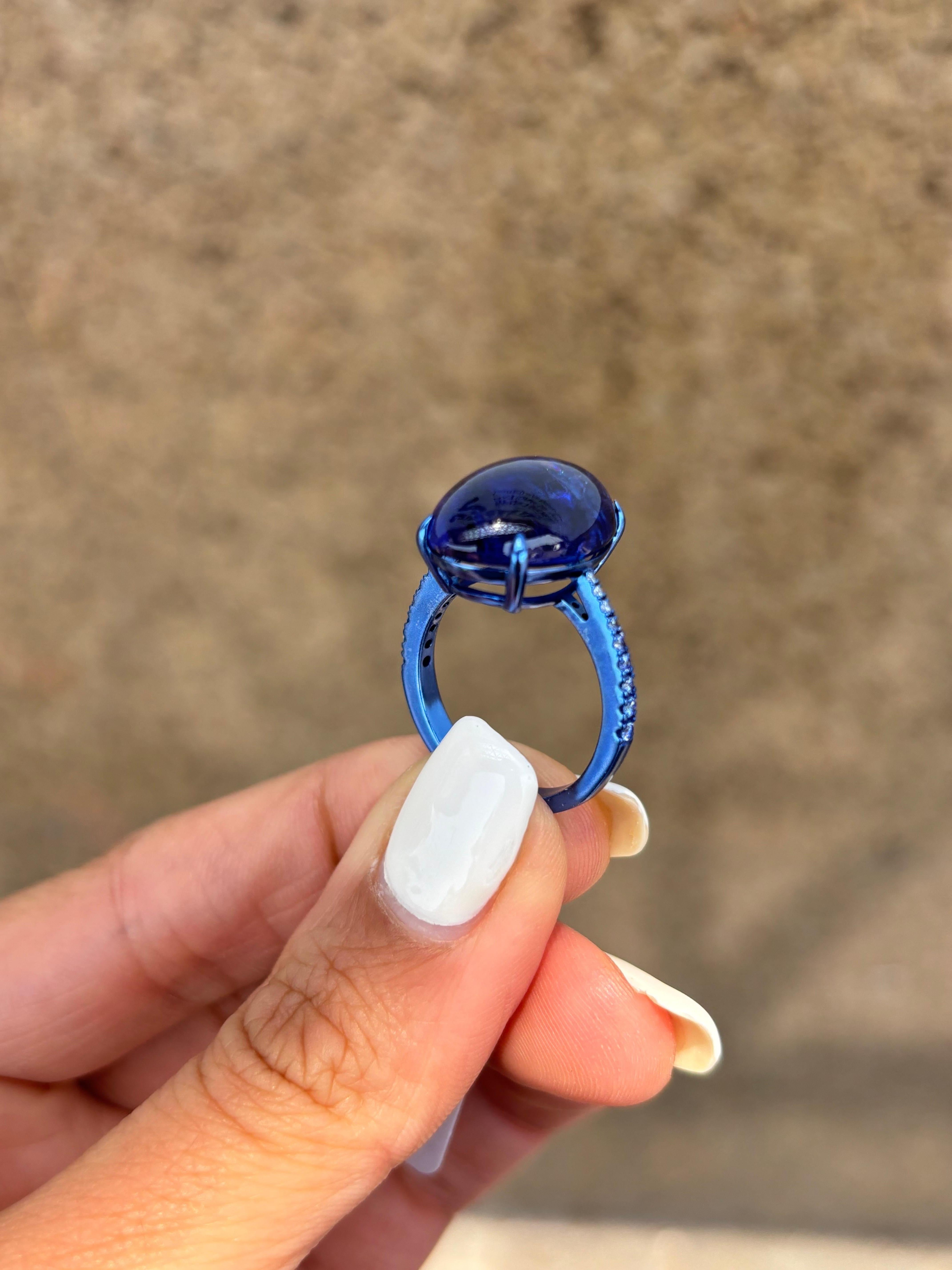 An eye catching, certified, 13.31 carat Tanzanite cabochon cocktail ring with 0.25 carat VS/SI quality Diamonds on the band. The natural Tanzanite, has a stunning hue and is transparent with few inclusions which makes it very unique. The gemstones