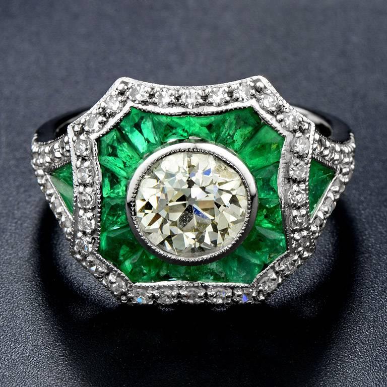 HKD Certified 1.35 Carat Old European Cut Diamond in the center with French-Cut Emerald 20 pieces Total 2.75 Carat Surrounded with 40 pieces 0.38 Carat Diamond.

The Ring was made in 18k White Gold Size US#7