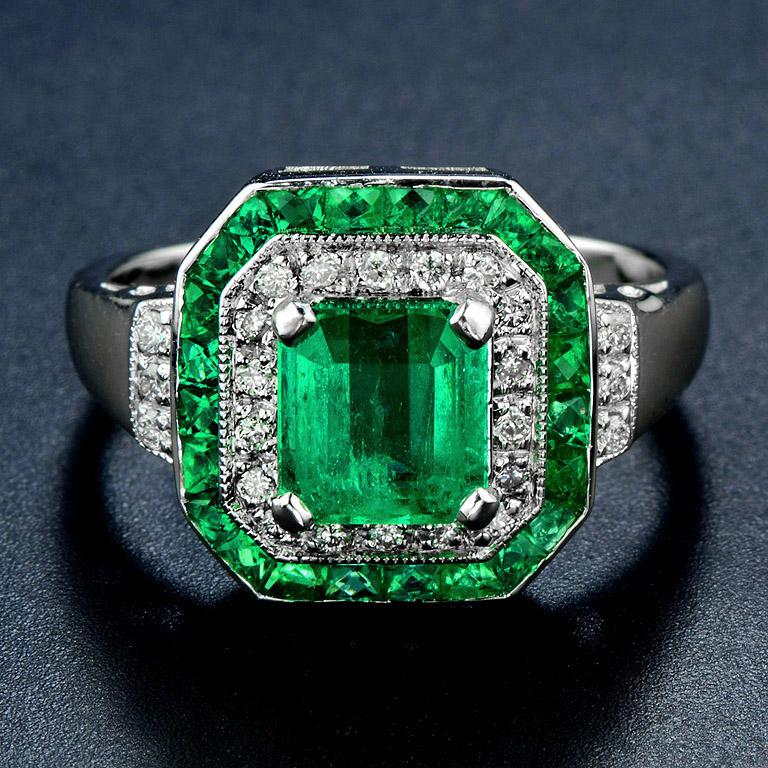 Certified 1.348 Carat Natural Emerald Octagon Shape Step Cut from Colombia. Surrounding by 18 pcs. Diamond and 6 pcs. on the shoulder and 24 pcs. French Cut Emerald 1.65 Carat. 

This Ring was made in 18k White Gold Size US#7

