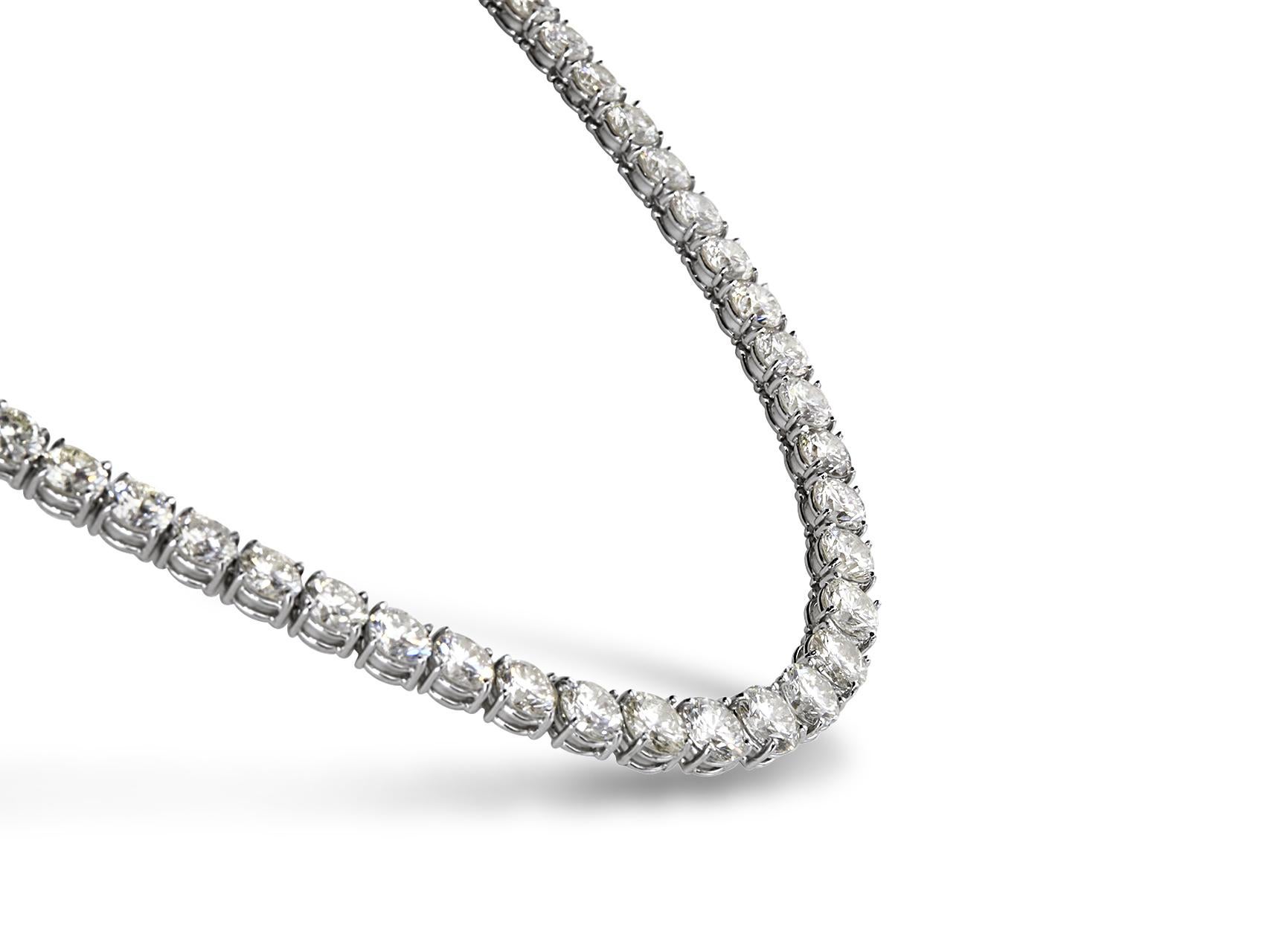 Classic 12.00 Carat Round Diamond 18'' Tennis Necklace in 14K White Gold. Certified by IGI Laboratory in New York, with full diamond jewelry grading report.

12.00 Carats of Brilliant Round White VS-SI Diamonds,
and 23.00 grams of 14K White