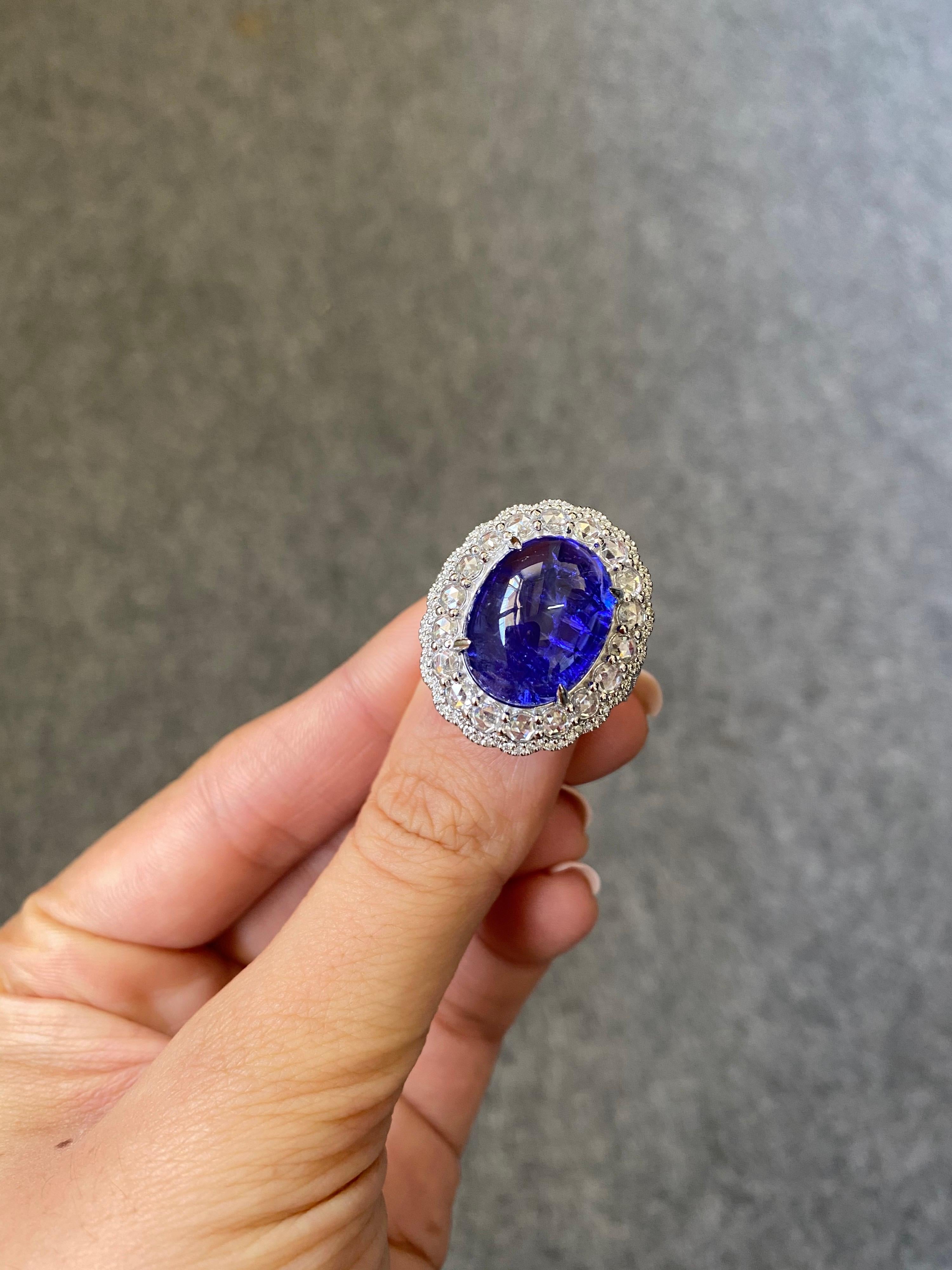A stunning 14.34 carat Tanzanite and Diamond cocktail ring, set in solid 18K White Gold. The Tanzanite is transparent, with an attractive blue-ish hue and great luster. Both, brilliant cut and rose cut White Diamonds are used to enhance the beauty