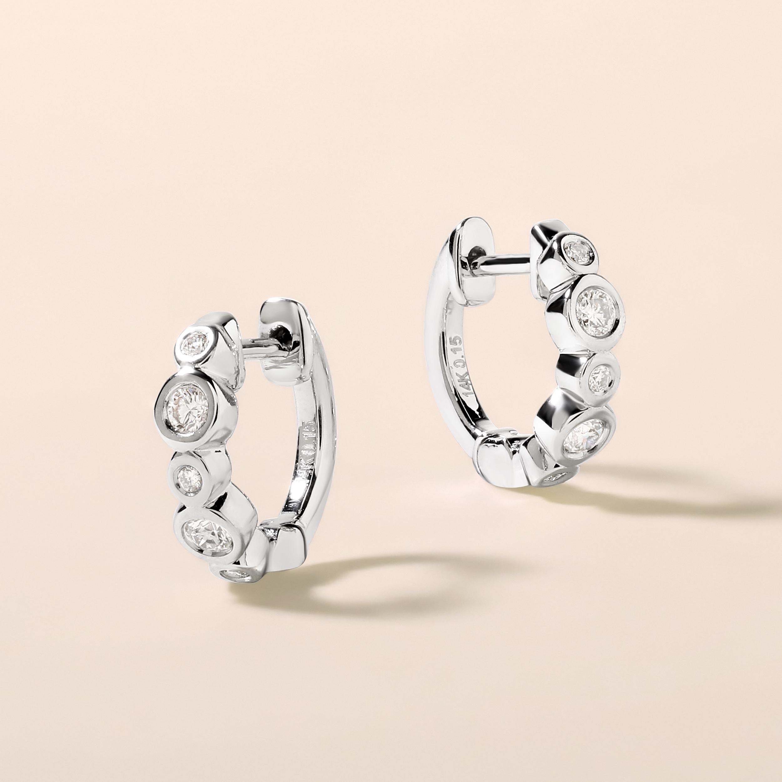 Crafted in 2.02 grams of 14K White Gold, the earrings contains 10 stones of Round Diamonds with a total of 0.15 carat in G-H color and SI clarity.

CONTEMPORARY AND TIMELESS ESSENCE: Crafted in 14-karat/18-karat with 100% natural diamond and