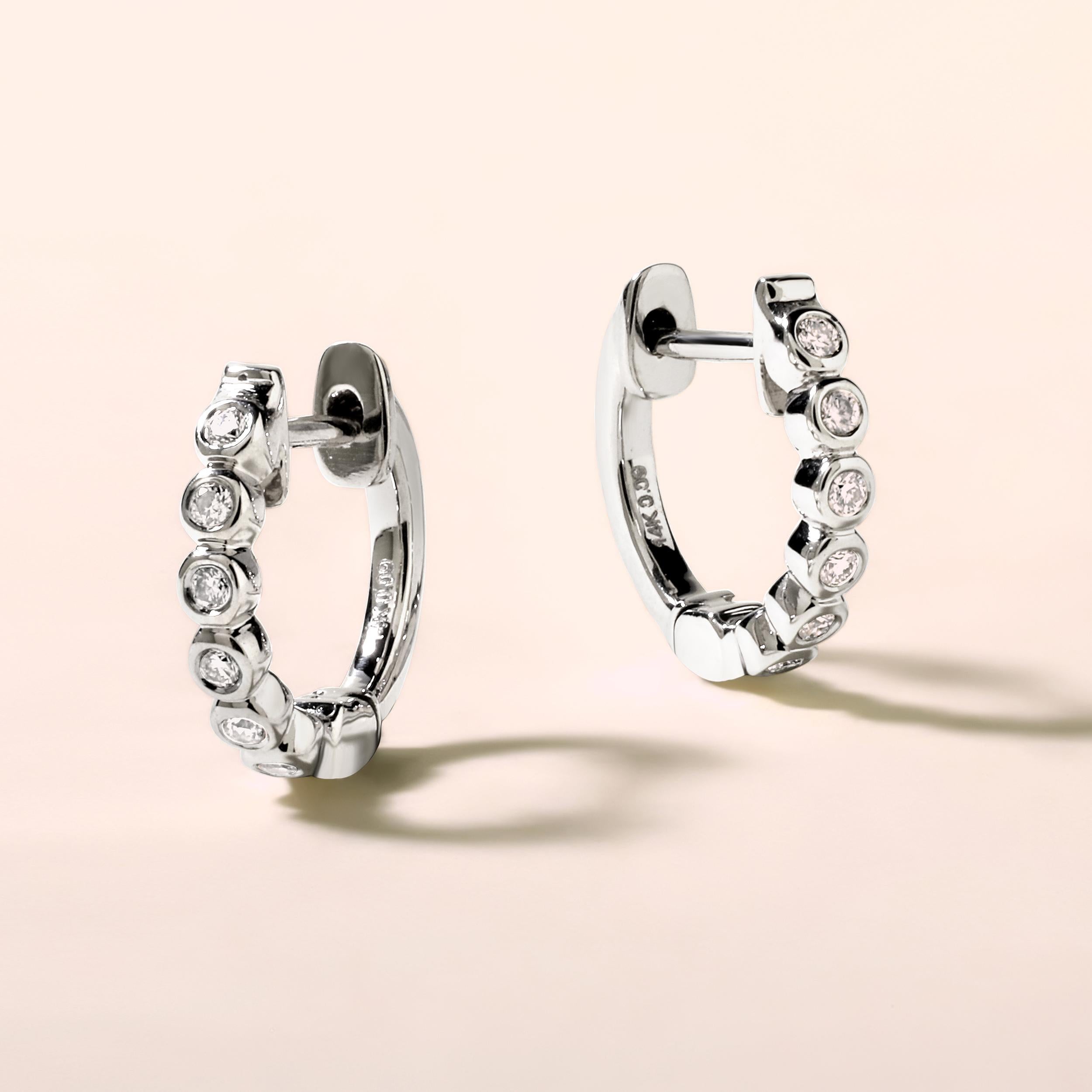 Crafted in 1.66 grams of 14K White Gold, the earrings contains 12 stones of Round Diamonds with a total of 0.09 carat in G-H color and SI clarity.
This jewelry piece will be expertly crafted by our skilled artisans upon order. Allow us a shipping