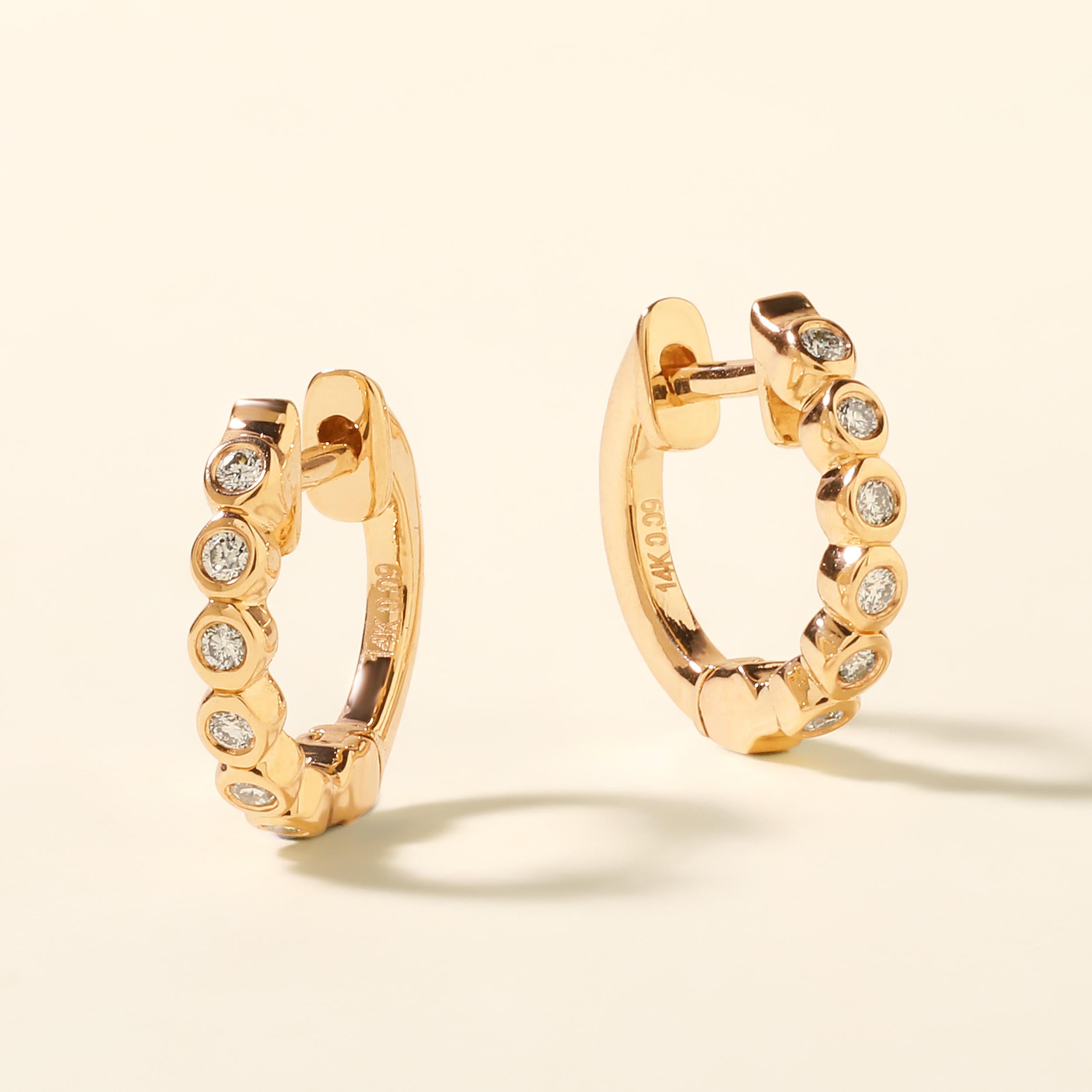 Crafted in 1.68 grams of 14K Yellow Gold, the earrings contains 12 stones of Round Diamonds with a total of 0.09 carat in G-H color and SI clarity.
This jewelry piece will be expertly crafted by our skilled artisans upon order. Allow us a shipping
