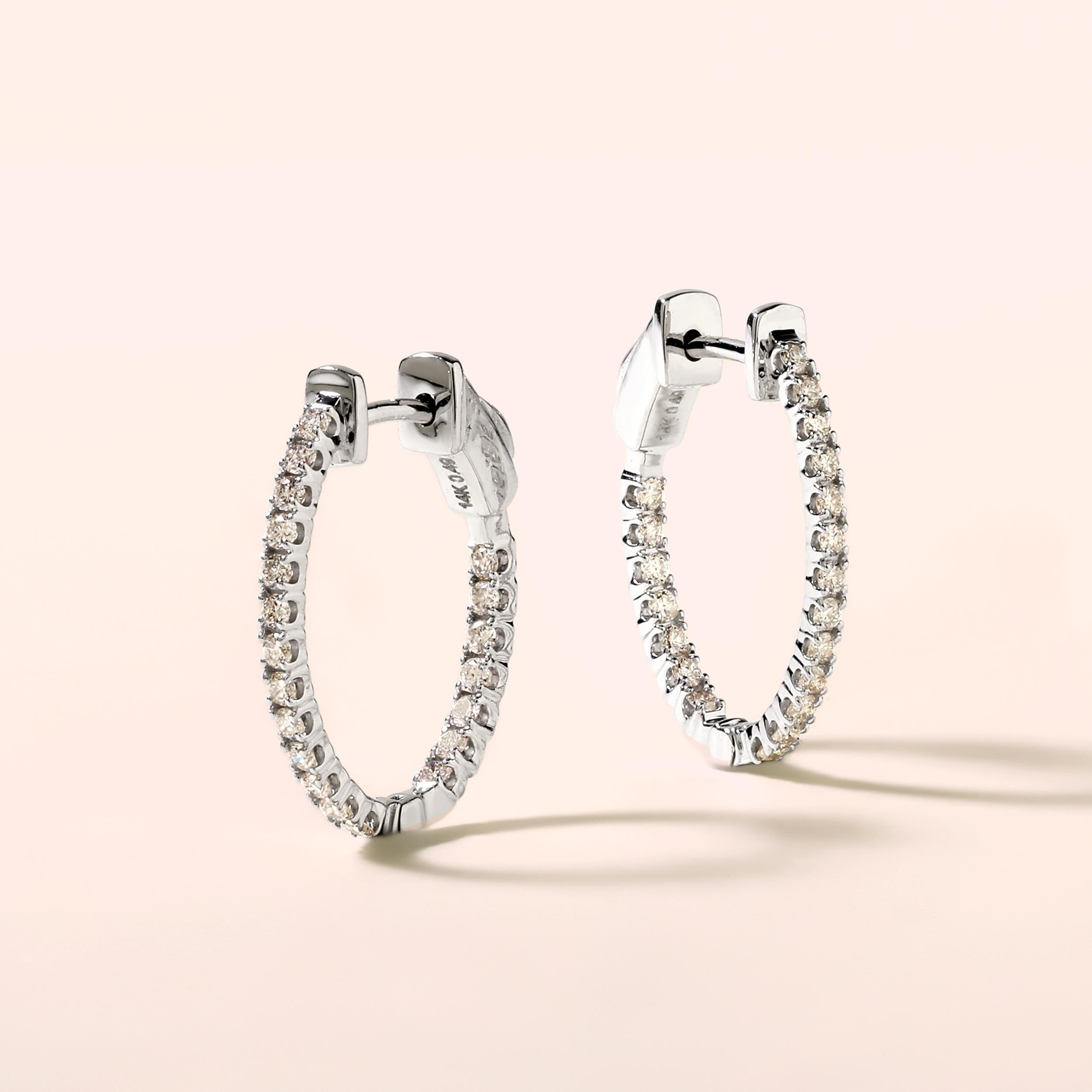 Crafted in 2.63 grams of 14K White Gold, the earrings contains 40 stones of Round Diamonds with a total of 0.49 carat in G-H color and SI clarity.

CONTEMPORARY AND TIMELESS ESSENCE: Crafted in 14-karat/18-karat with 100% natural diamond and