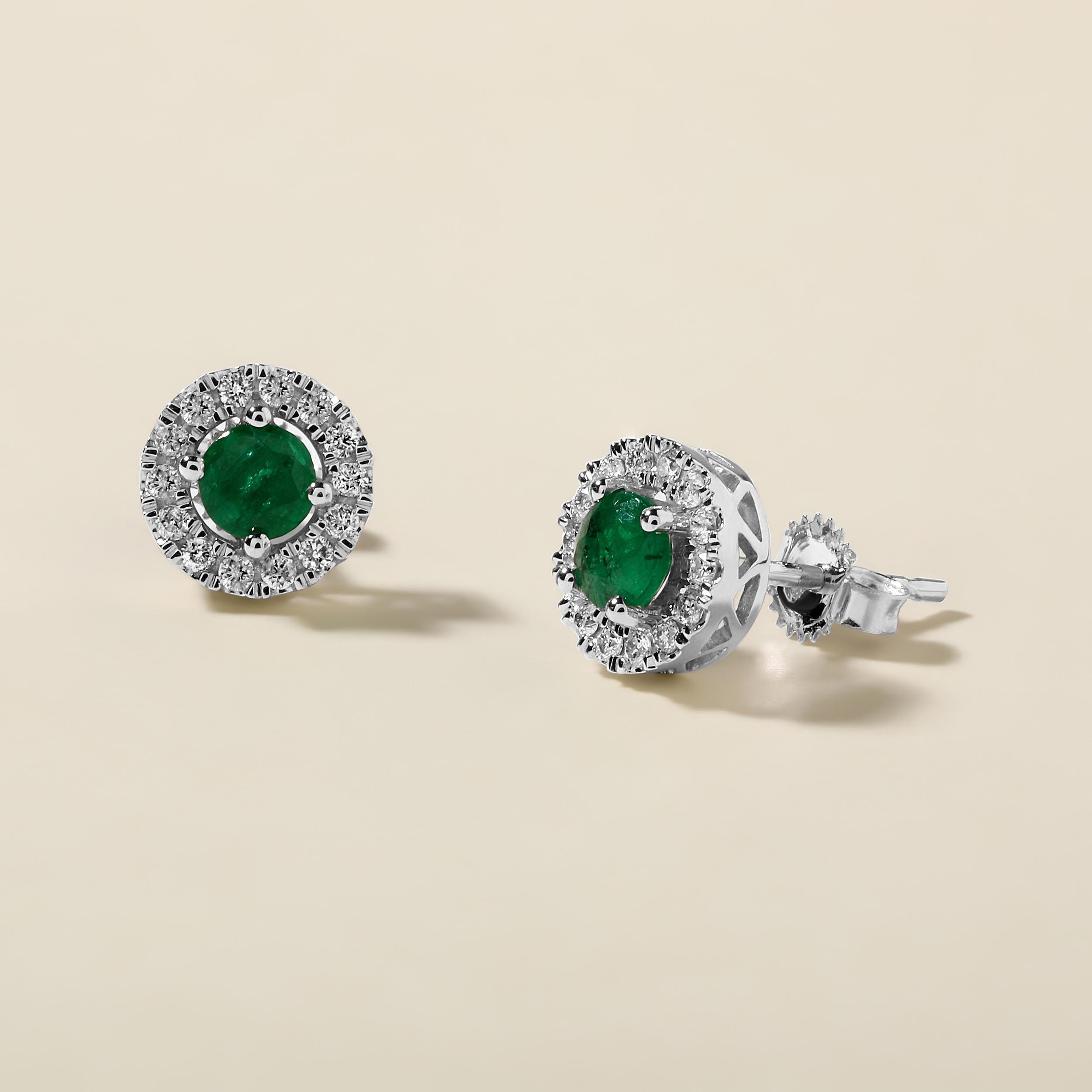 Crafted in 2.44 grams of 14K White Gold, the earrings contain 36 stones of Round Natural Diamonds with a total of 0.29 carat in F-G color and I1-I2 clarity combined with 2 stones of Round Shaped Natural Emerald Gemstones with a total of 1.12