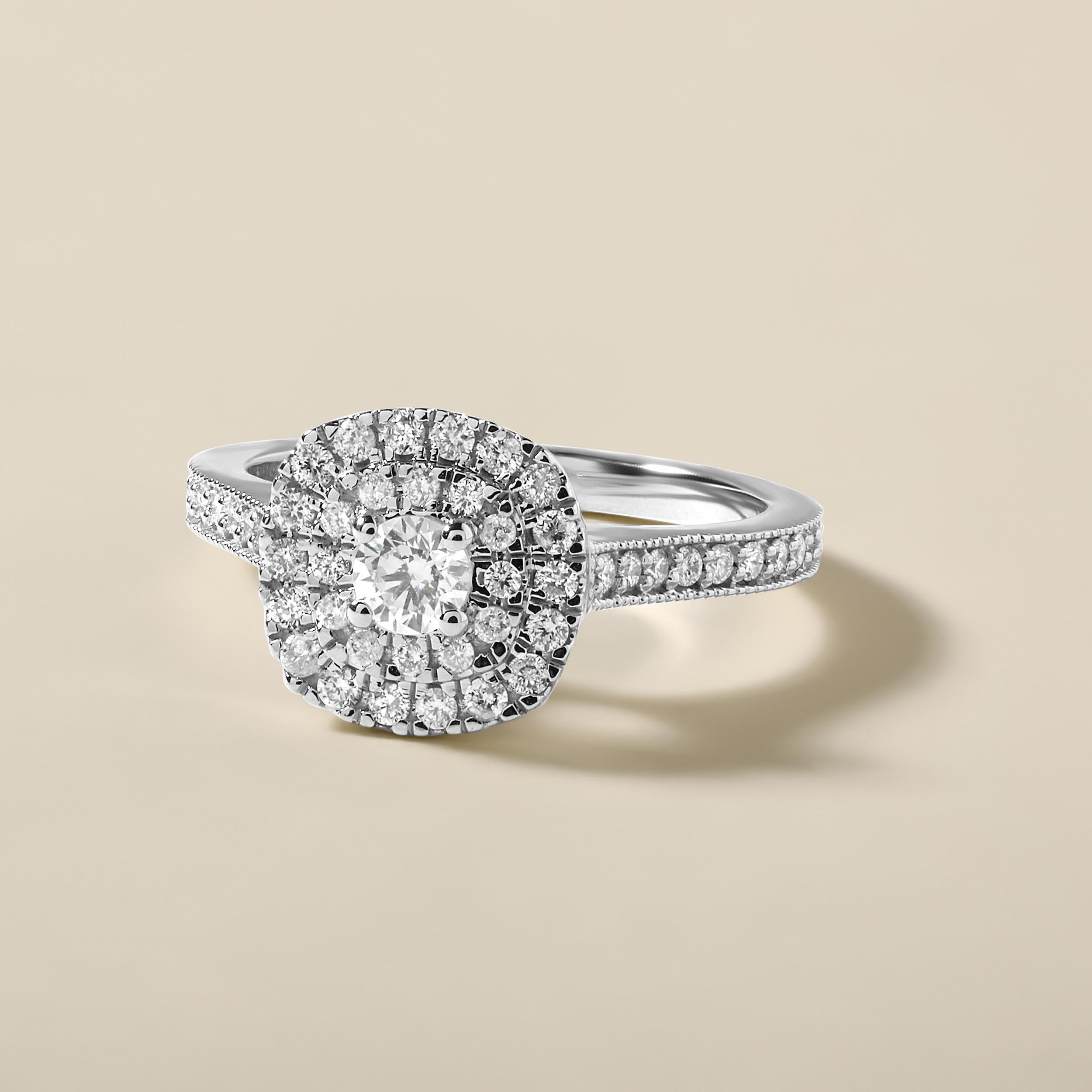 Ring Size: US 7

Crafted in 4.6 grams of 14K White Gold, the ring contains 50 stones of Round Natural Diamonds with a total of 0.55 carat in F-G color and I1-I2 clarity combined with 1 stone of Round Solitaire Natural Diamond with a total of 0.16