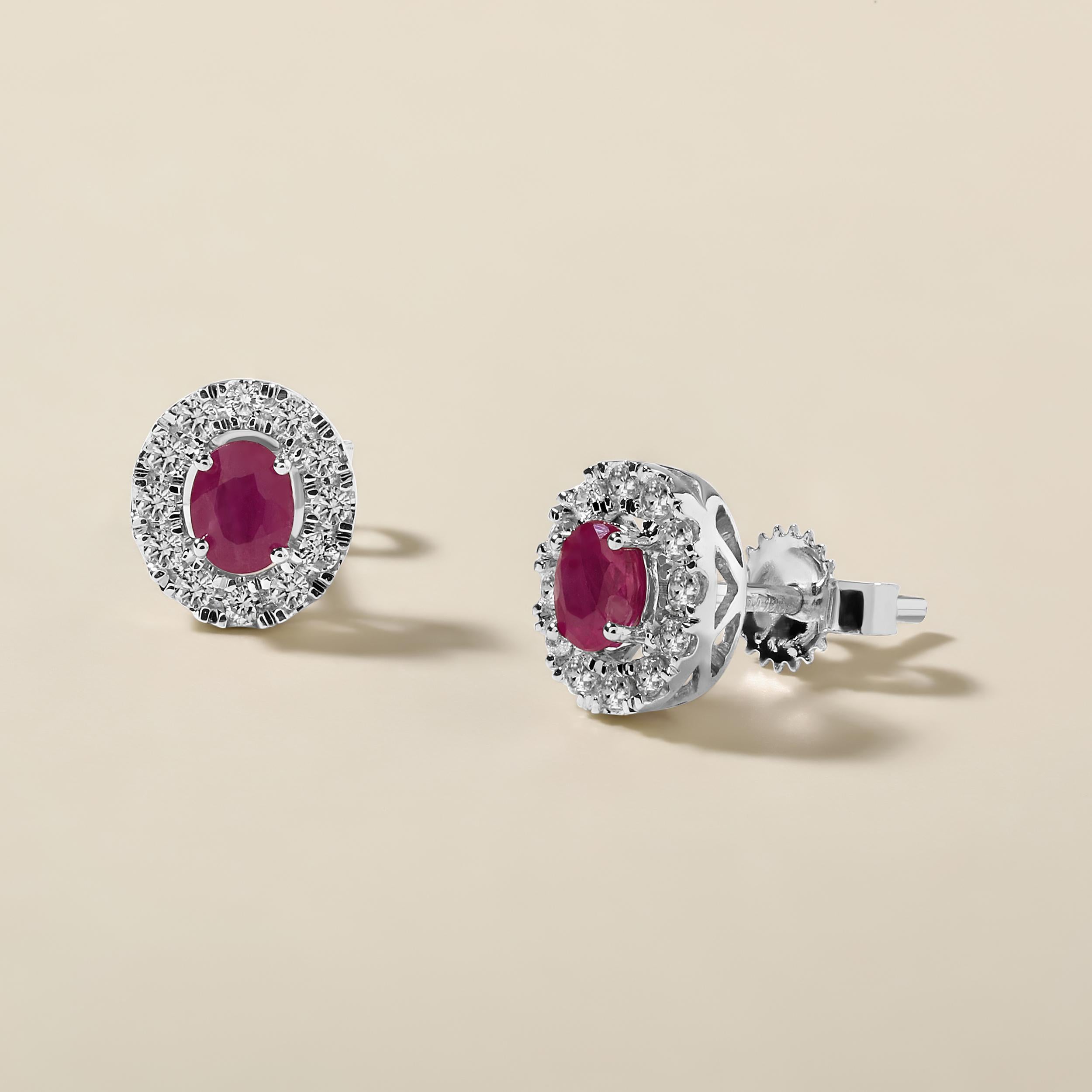 Crafted in 1.37 grams of 14K White Gold, the earrings contain 24 stones of Round Natural Diamonds with a total of 0.19 carat in F-G color and I1-I2 clarity combined with 2 stones of Oval Shaped Natural Ruby Gemstones with a total of 0.52