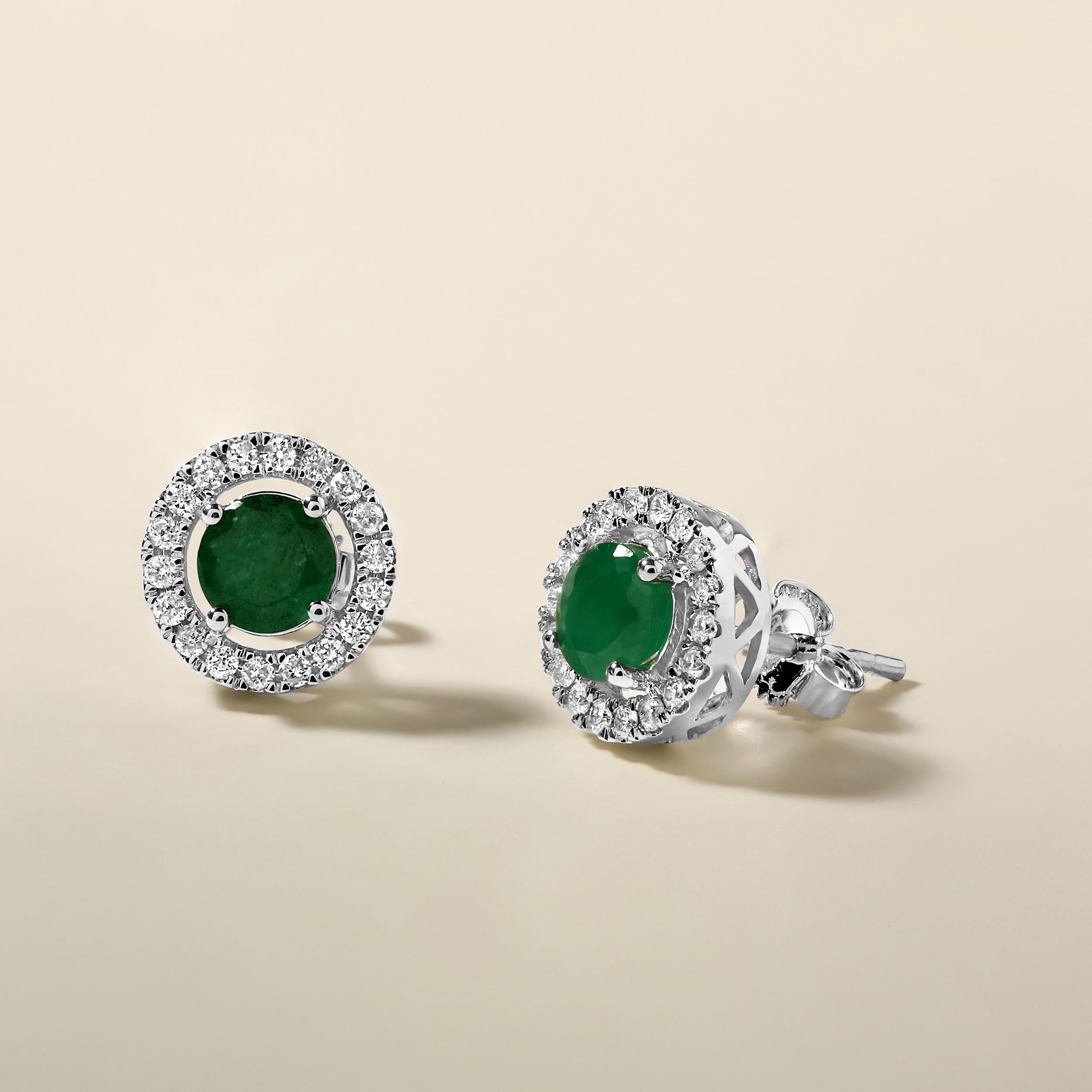 Crafted in 2.44 grams of 14K White Gold, the earrings contain 36 stones of Round Natural Diamonds with a total of 0.29 carat in F-G color and I1-I2 clarity combined with 2 stones of Round Shaped Natural Emerald Gemstones with a total of 1.12