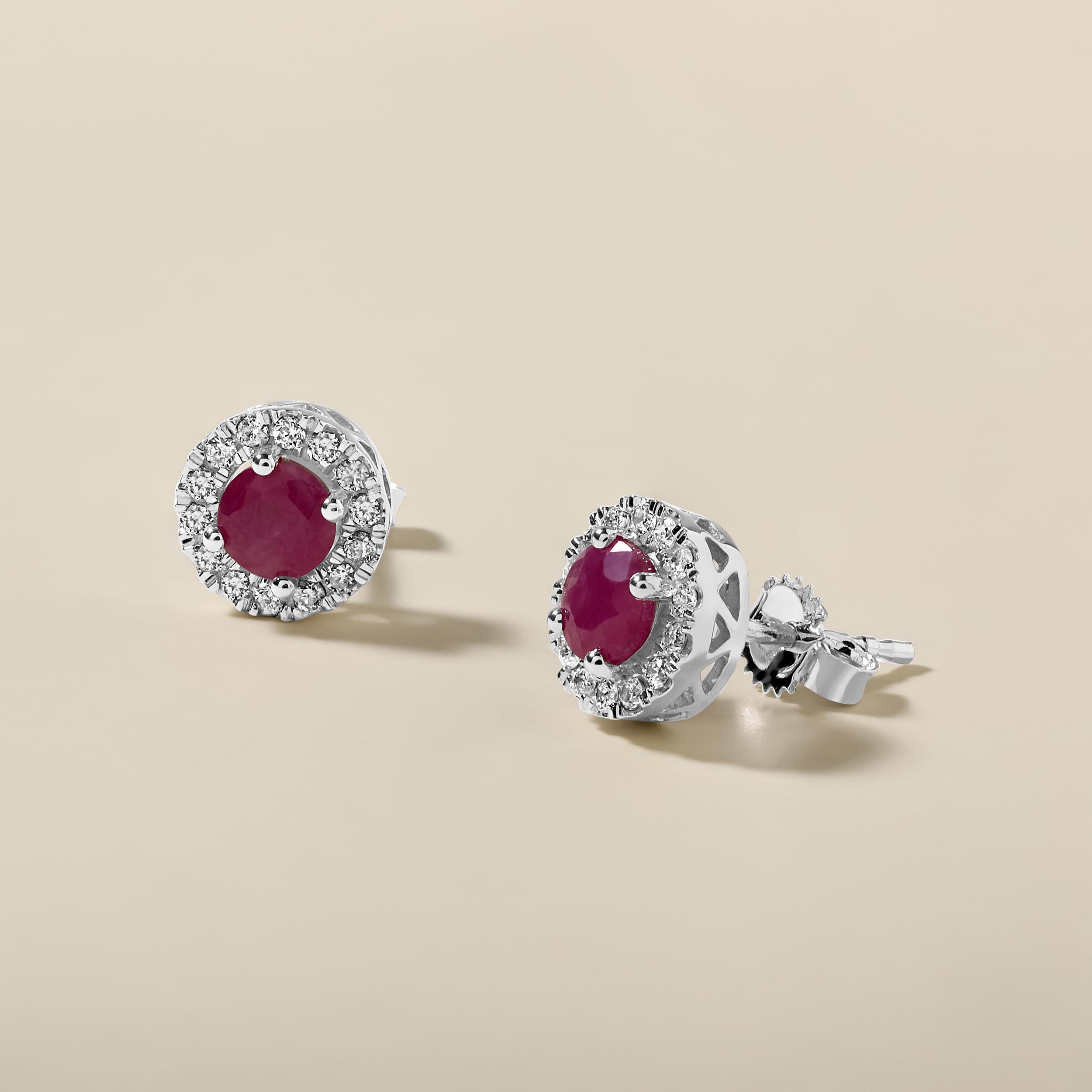 Crafted in 2.62 grams of 14K White Gold, the earrings contain 36 stones of Round Natural Diamonds with a total of 0.29 carat in F-G color and I1-I2 clarity combined with 2 stones of Round Shaped Natural Ruby Gemstones with a total of 1.27