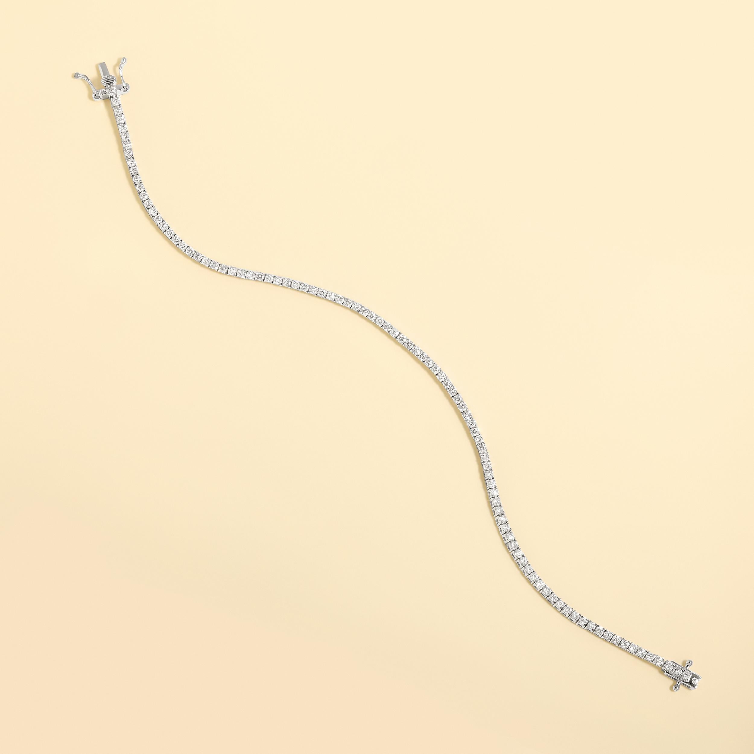 Crafted in 5.45 grams of 14K White Gold, the bracelet contains 95 stones of Round Natural Diamonds with a total of 1.98 carat in G-H color and VS-SI clarity. The bracelet length is 7 inches.

CONTEMPORARY AND TIMELESS ESSENCE: Crafted in