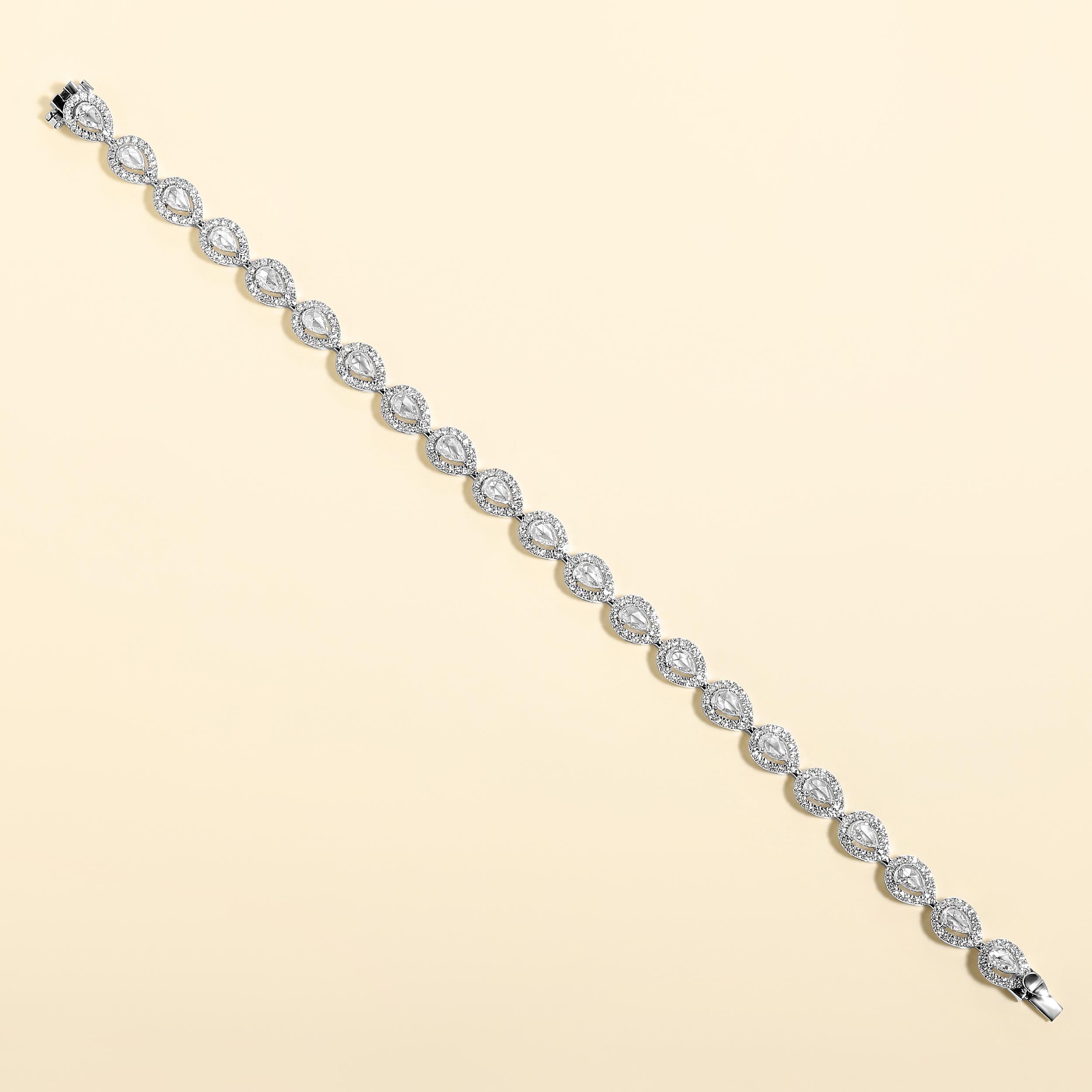 Crafted in 12.87 grams of 14K White Gold, the bracelet contains 357 stones of Round Natural Diamonds with a total of 1.48 carat in F-G color and VVS-VS clarity combined with 21 stones of Pear-Shaped Rose-Cut Natural Diamonds with a total of 1.73
