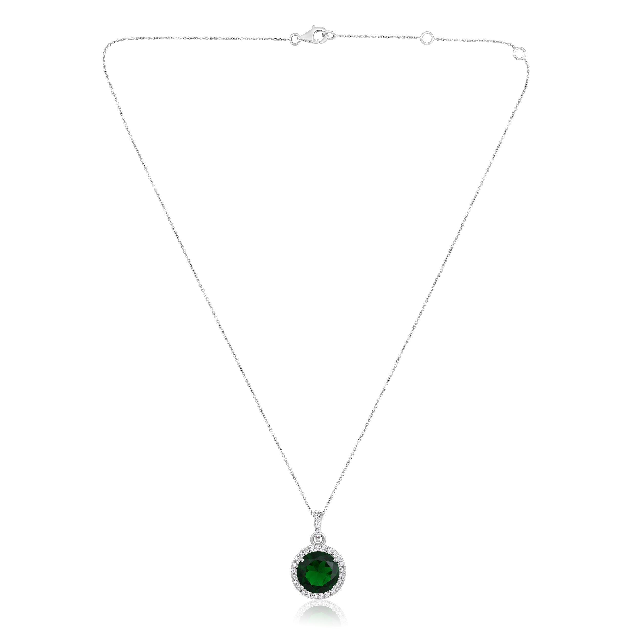 Crafted in 3.51 grams of 14K White Gold, the necklace contains 30 stones of Round Diamonds with a total of 0.35 carat in F-G color and I1-I2 clarity combined with 1 stone of Lab Created Emerald Gemstone with a total of 2.85 carat. The necklace
