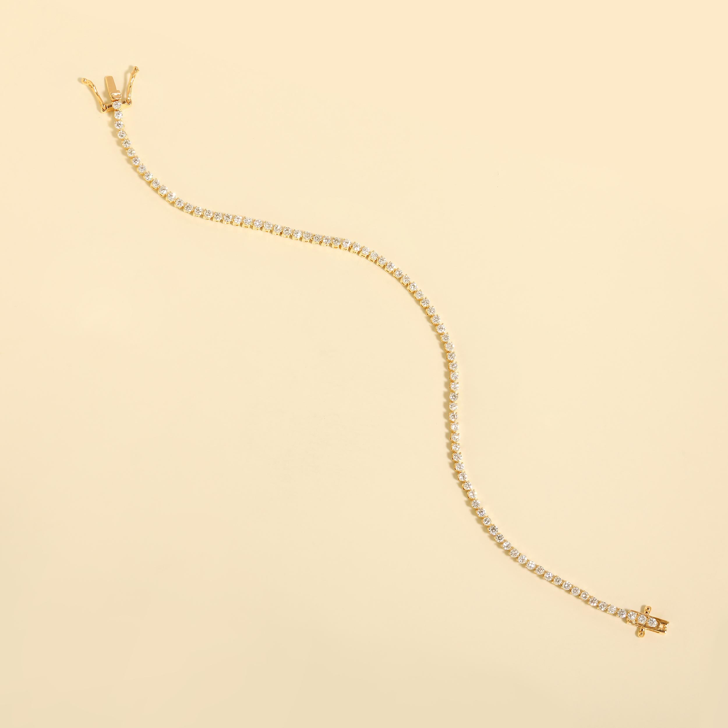 Crafted in 7.67 grams of 14K Yellow Gold, the bracelet contains 66 stones of Round Natural Diamonds with a total of 2.93 carat in G-H color and VS-SI clarity. The bracelet length is 7 inches.

CONTEMPORARY AND TIMELESS ESSENCE: Crafted in