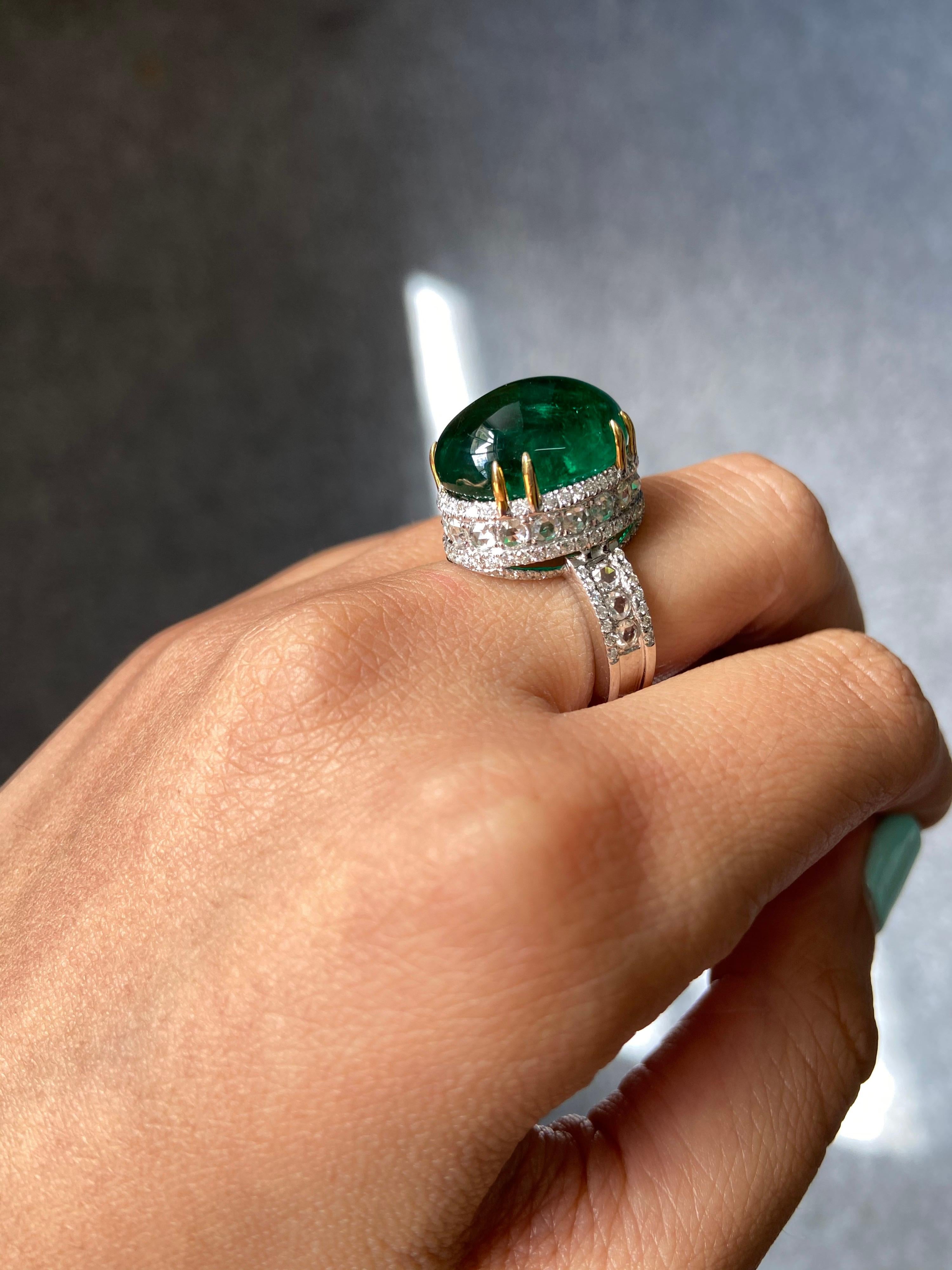 A gorgeous Zambian Emerald cabochon centre stone weighing 15.58 carats, with an intense green colour and high lustre, completely transparent; sorrounded by diamonds all set in 18K white gold. Free shipping provided. Free resizing service. Returns